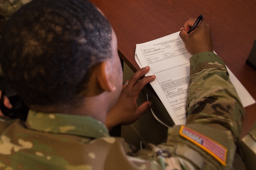 A U.S. Army Soldier with fills out paperwork for the Army Emergency Relief program at Joint Base Langley-Eustis, Virginia, Feb. 26, 2018.