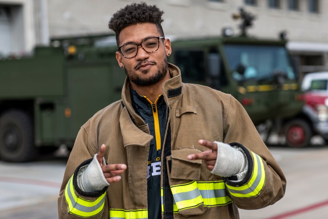 Kendall James, cornerback for the San Diego Fleet football team, poses for a photo in front of Marine Corps Air Station Miramar’s Aircraft Rescue and Firefighting station at MCAS Miramar, Calif., Feb. 26. The San Diego Fleet football team visited MCAS Miramar to further foster cohesion between the San Diego community and MCAS Miramar. (U.S. Marine Corps photo by Sgt. Jake McClung)