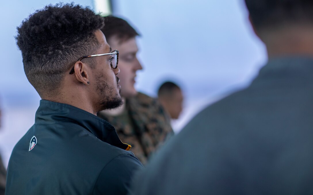 Kendall James, cornerback for the San Diego Fleet football team, left, attends a tour of the Marine Corps Air Station Miramar air traffic control tower at MCAS Miramar, Calif., Feb. 26. The San Diego Fleet football team visited MCAS Miramar to further foster cohesion between the San Diego community and MCAS Miramar. (U.S. Marine Corps photo by Sgt. Jake McClung)