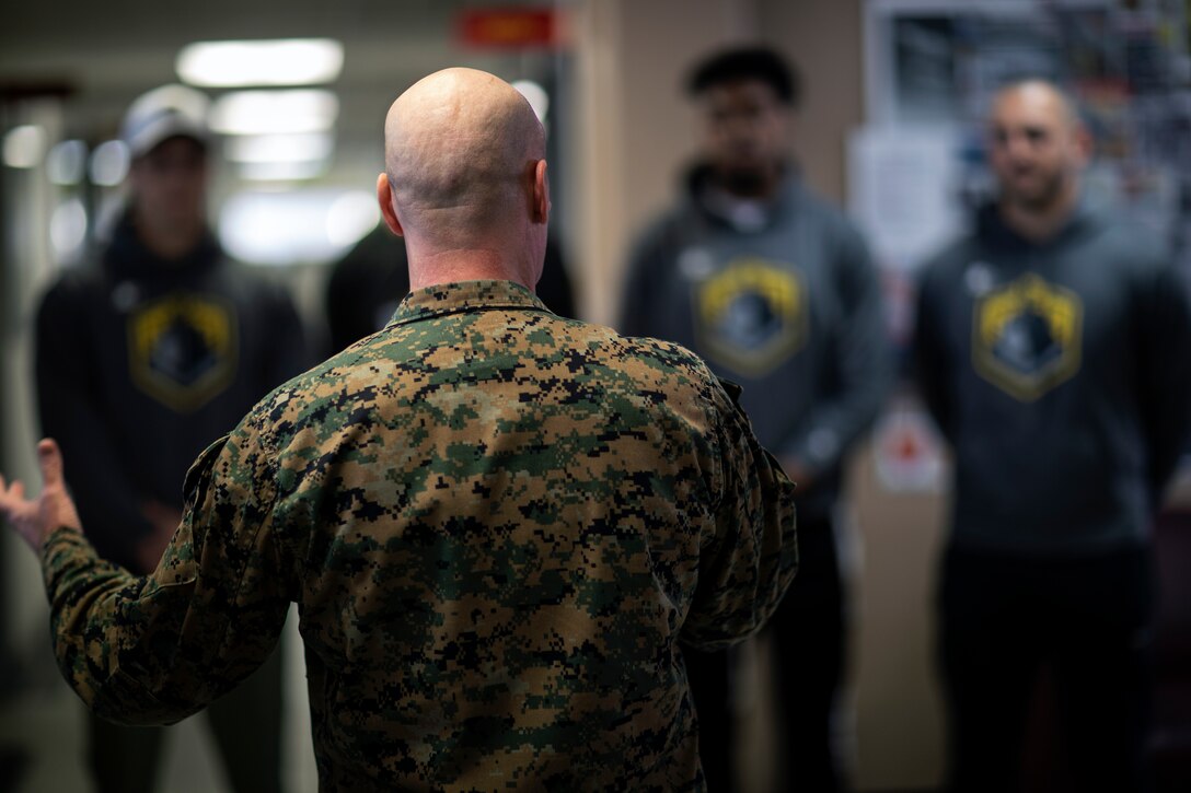 Sgt. Maj. Michael N. Walton, sergeant major of Marine Corps Air Station Miramar, briefs members of the San Diego Fleet football team before they tour MCAS Miramar at MCAS Miramar, Calif., Feb. 26. The San Diego Fleet football team visited MCAS Miramar to further foster cohesion between the San Diego community and MCAS Miramar. (U.S. Marine Corps photo by Sgt. Jake McClung)