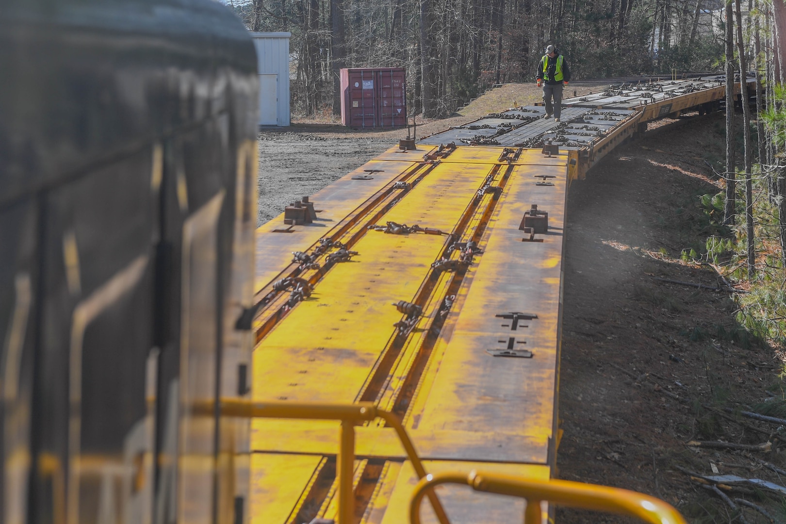 Thomas DeRosier, 733rd Logistics Readiness Squadron Transportation utility rail branch locomotive engineer, checks flatcars at Joint Base Langley-Eustis, Virginia, Feb. 15, 2019. The U.S. Army started planning a railroad at Fort Eustis in May 1918, shortly after establishing the installation in March 1918. (U.S. Air Force photo by Senior Airman Derek Seifert)