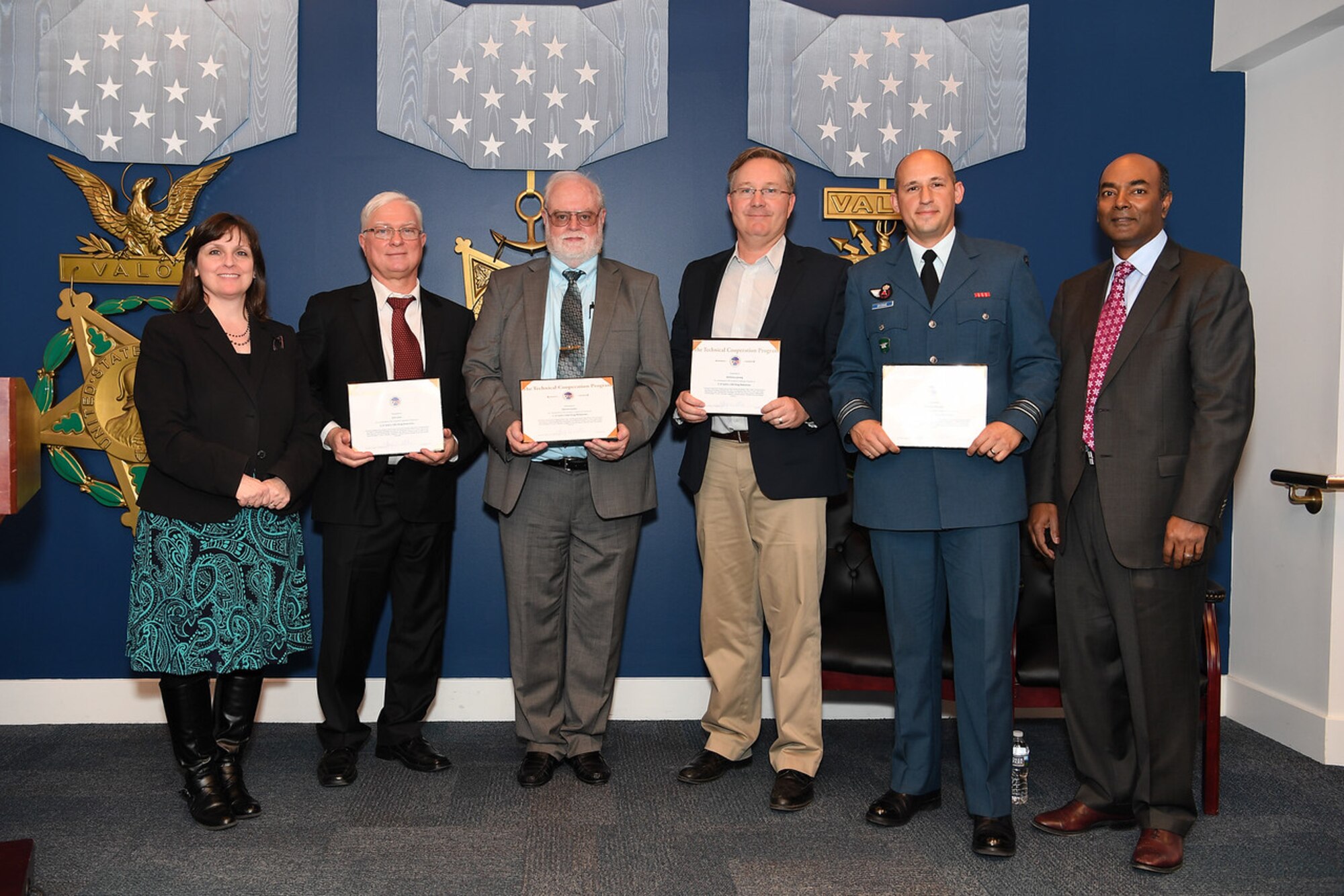 The Legacy Fleet Drag Reduction Program was awarded the Technical Cooperation Program (TTCP) Team Award Feb. 6 during a ceremony held at the Pentagon. AFRL’s Dennis Carter, Senior Aerospace Engineer with the Aerospace Systems Directorate, and other members of his team, including John Carr and Tony Lorang from Boeing, and Maj. Greg Givogue from the Royal Canadian Air Force, were presented the award for efforts in reducing the aerodynamic drag of the C-130 and C-17 aircraft. This was a joint effort between Australia, Canada, the United Kingdom and the United States, potentially reducing the fuel burned by the United States Air Force by $30 million annually. Pictured (left to right): Mary J. Miller, Principal Deputy Director of Defense Research and Engineering for Research and Development; Carr, Carter, Lorang, Givogue and Dr. Jagadeesh Pamulapati, Director Laboratories. (U.S. Army photo by Mr. Leroy Council)