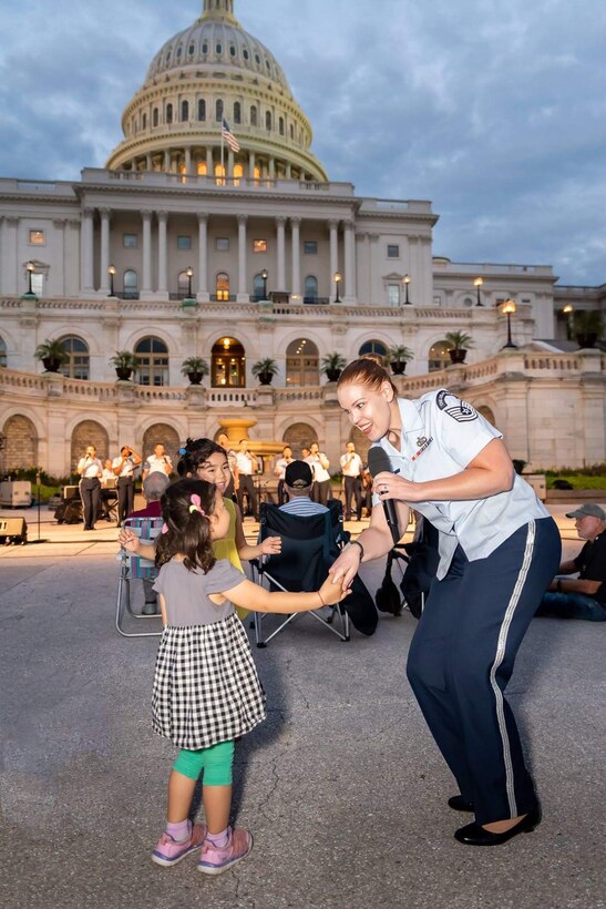 Vocalist dances with audience members.