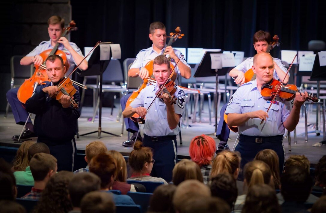 Strolling Strings perform for high school students.