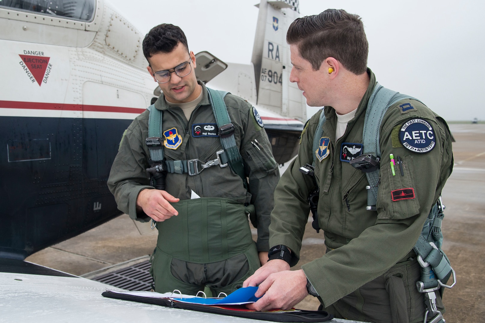 Capt. Ray Stone (right), Pilot Training Next instructor pilot, and 2nd Lt. Naji Bseiso, PTN student, go over flying procedures prior to a training mission at Austin-Bergstrom International Airport in Austin, Texas, Feb. 5, 2019. The current PTN class is comprised of 26 students, including 16 active duty officer students (six of whom are participating in a remotely-piloted aircraft only track), two Air National Guard officers, two U.S. Navy officers, one Royal Air Force officer, and five enlisted Airmen. (U.S. Air Force photo by Sean M. Worrell)