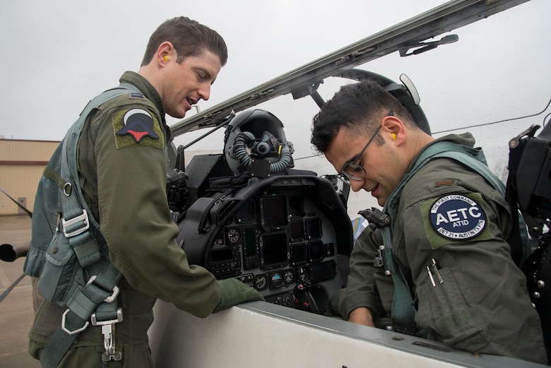 Capt. Ray Stone (right), Pilot Training Next instructor pilot, ensures Second Lt. Naji Bseiso, PTN student, is properly strapped into the T-6 Texan aircraft prior to a training mission at Austin-Bergstrom International Airport in Austin, Texas, Feb. 5, 2019. The current PTN class, which began Jan. 17, 2019, is comprised of 26 students, including 16 active duty officer students (six of whom are participating in a remotely-piloted aircraft only track), two Air National Guard officers, two U.S. Navy officers, one Royal Air Force officer, and five enlisted Airmen. (U.S. Air Force photo by Sean M. Worrell)