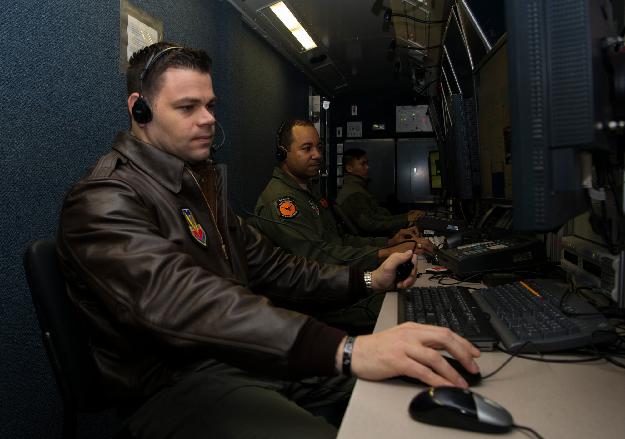 Master Sgt. Mike, 12th Reconnaissance Squadron RQ-4 Global Hawk pilot, and Tech. Sgt. Robert, 12th RS RQ-4 sensor operator, simulate flying operations in a mission control element