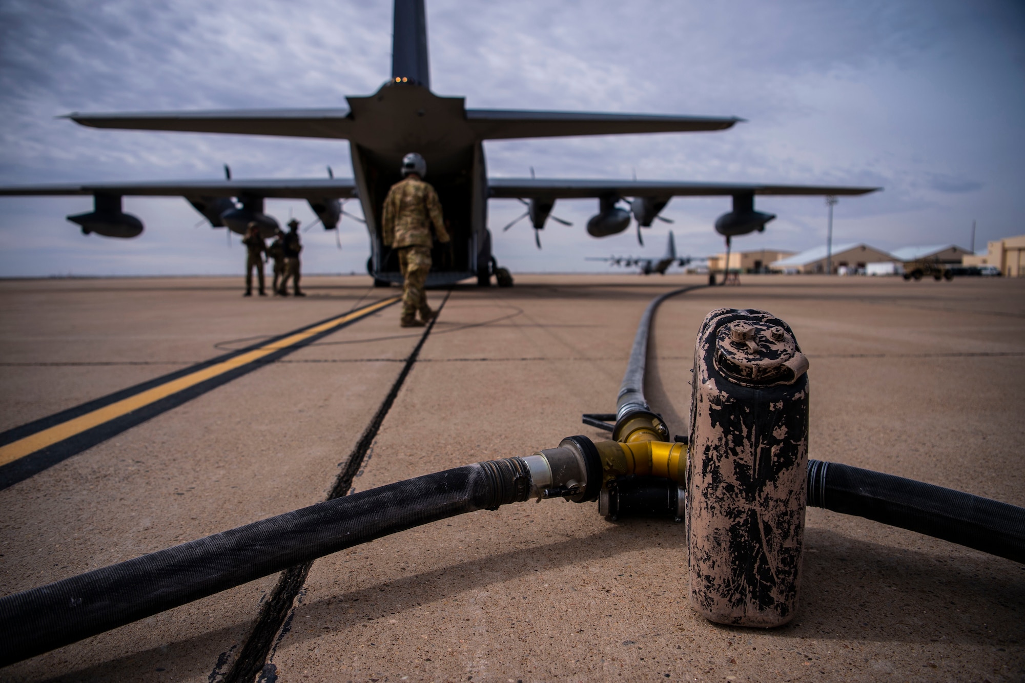 A refueling hose splits in two directions out of the back of a MC-130J during the start of Forward Area Refueling Point training for F-35A aircraft at Cannon Air Force Base, N.M., Feb. 27, 2019. This was the first time FARP training was conducted by an MC-130J for the F-35A aircraft as it expands its reach and capabilties. (U.S. Air Force photo by Staff Sgt. Luke Kitterman)