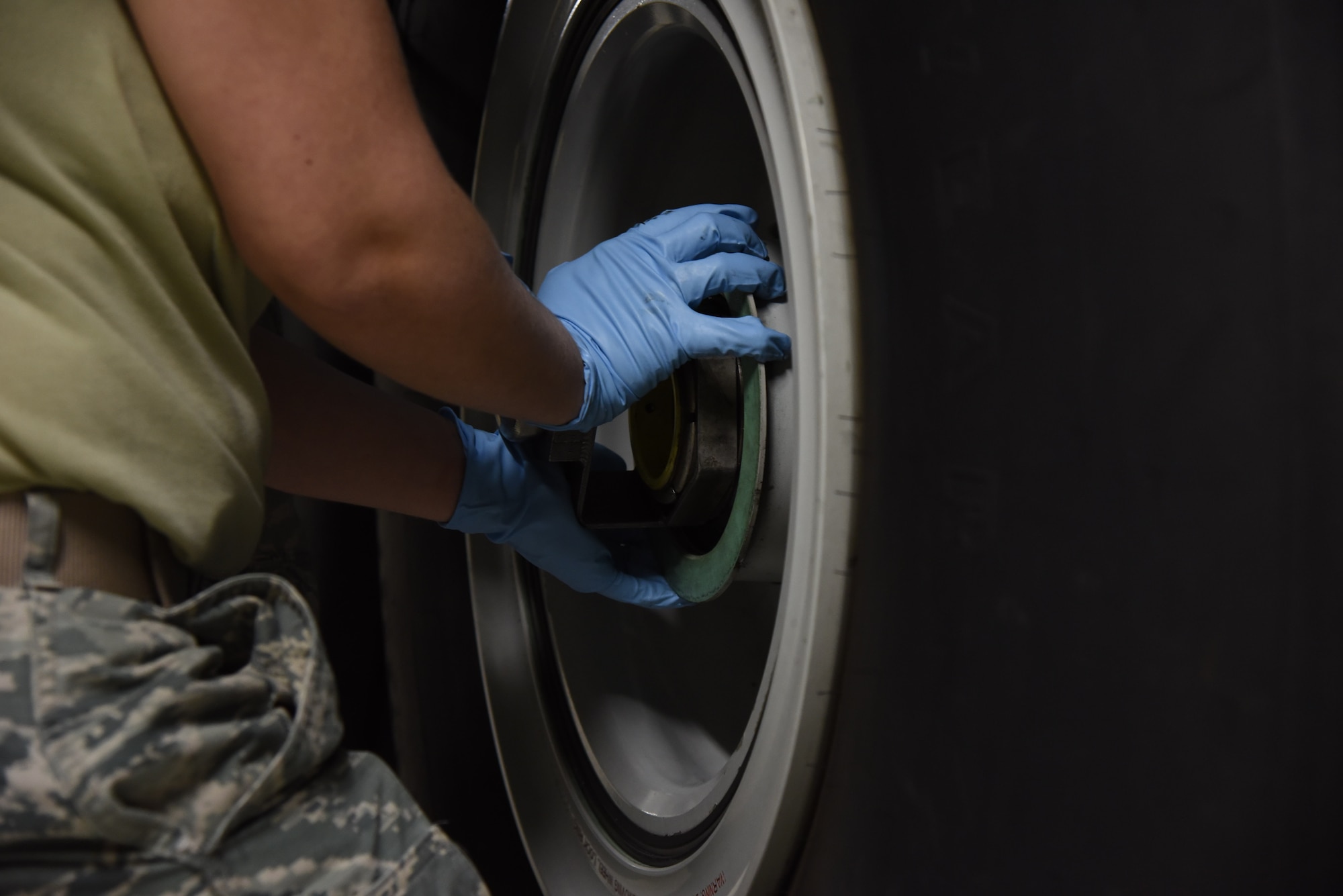 Senior Airman Landis Lee, 403rd Maintenance Squadron crew chief, prepares a tire for removal from a WC-130J  Jan. 13, 2019. This is a requirement that is performed during the routine inspections required to the maintain the aircraft's capabilities. (U.S. Air Force photo by Senior Airman Kristen Pittman)