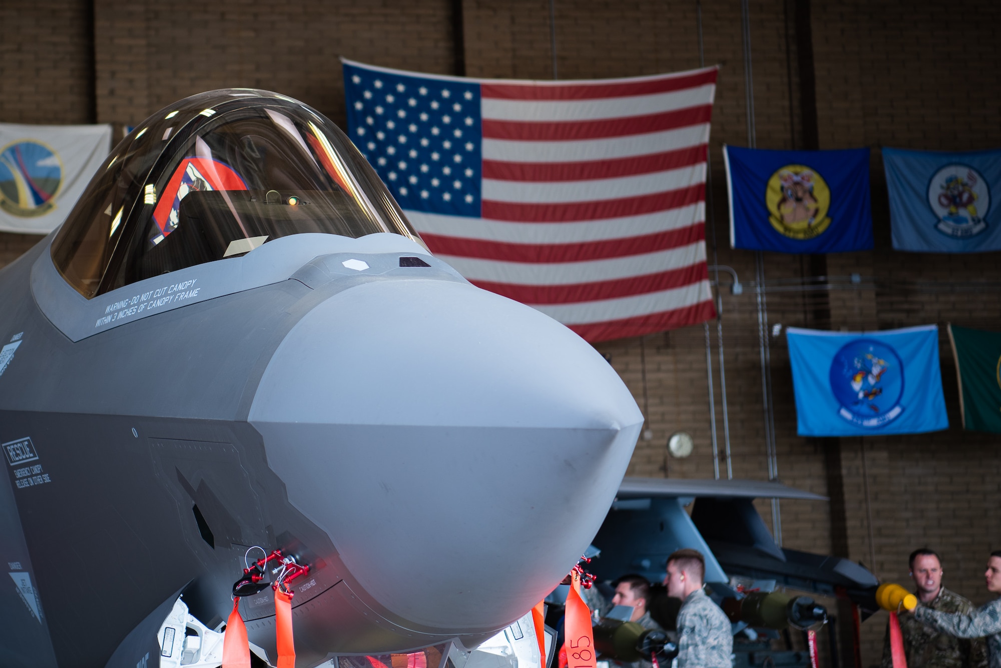 The F-35A Lightning II sits in a hangar loaded with dummy external munitions, Feb. 13, 2019 at Luke Air Force Base, Ariz. The F-35 brings together strategic international partnerships and alliances, where it will employ a variety of US and allied weapons. (U.S. Air Force photo by Airman 1st Class Aspen Reid)