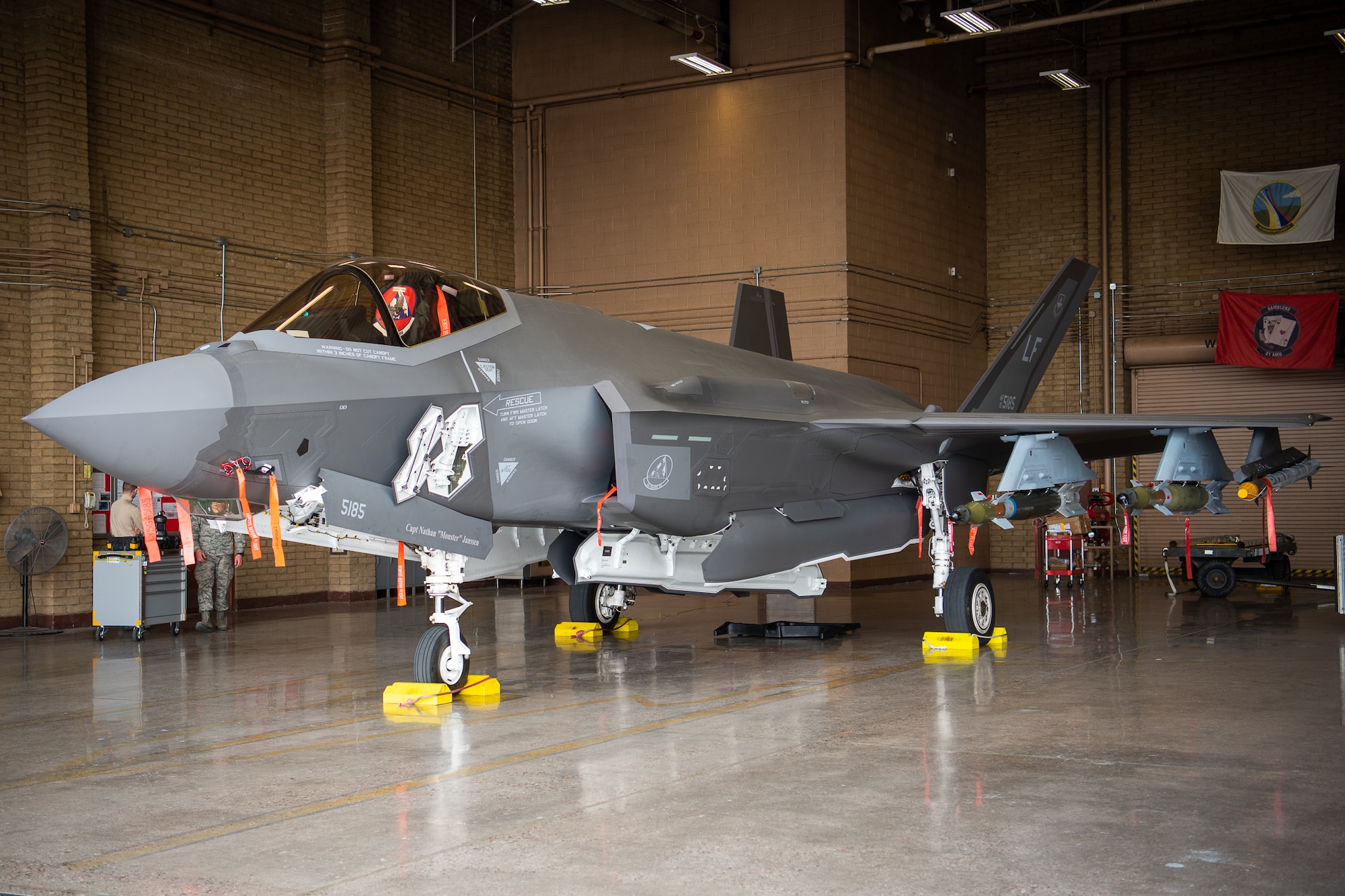 The F-35A Lightning II sits in a hangar loaded with dummy external munitions, Feb. 13, 2019 at Luke Air Force Base, Ariz. After completing the external pylon installation training, the weapons loading standardization crew, a team of three Airmen, became the first team at Luke to be certified on external GBU-12 bomb and AIM-9 missile loading. (U.S. Air Force photo by Airman 1st Class Aspen Reid)
