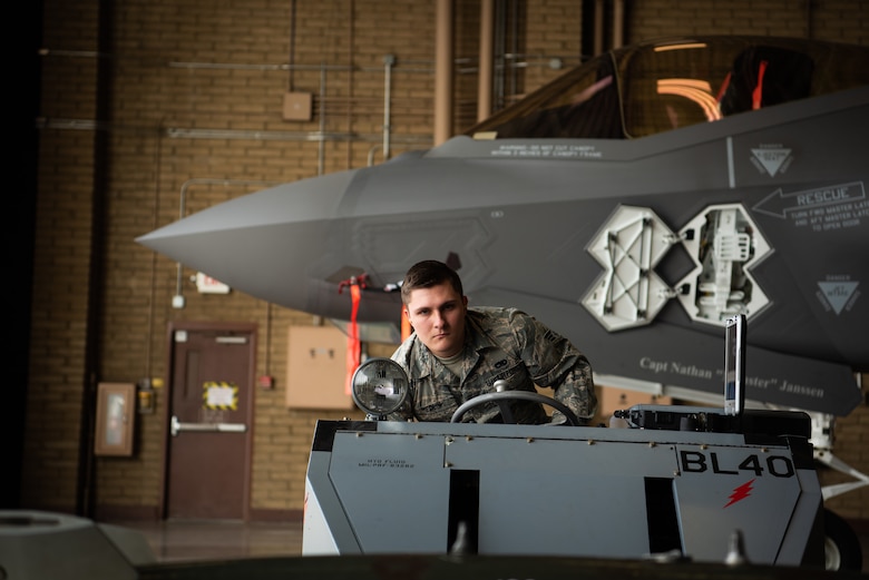 Senior Airman Hunter Medlin, 56th Component Maintenance Squadron load crew member, maneuvers a jammer underneath a dummy missile, Feb. 13, 2019 at Luke Air Force Base, Ariz. Medlin was part a three-man team receiving their certification on loading external munitions on an F-35A Lightning II. (U.S. Air Force photo by Airman 1st Class Aspen Reid)