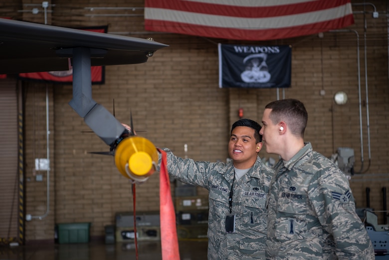 Tech Sgt. RC Craig Carnate-Ramo and Senior Airman Levi Aydt, 56th Component Maintenance Squadron load crew members, discuss mounting techniques of external ammunitions on the F-35A Lightning II, Feb. 13, 2019 at Luke Air Force Base, Ariz. This is the first time Luke weapons Airmen installed external pylons, and loaded external bombs and missiles on an F-35. (U.S. Air Force photo by Airman 1st Class Aspen Reid)