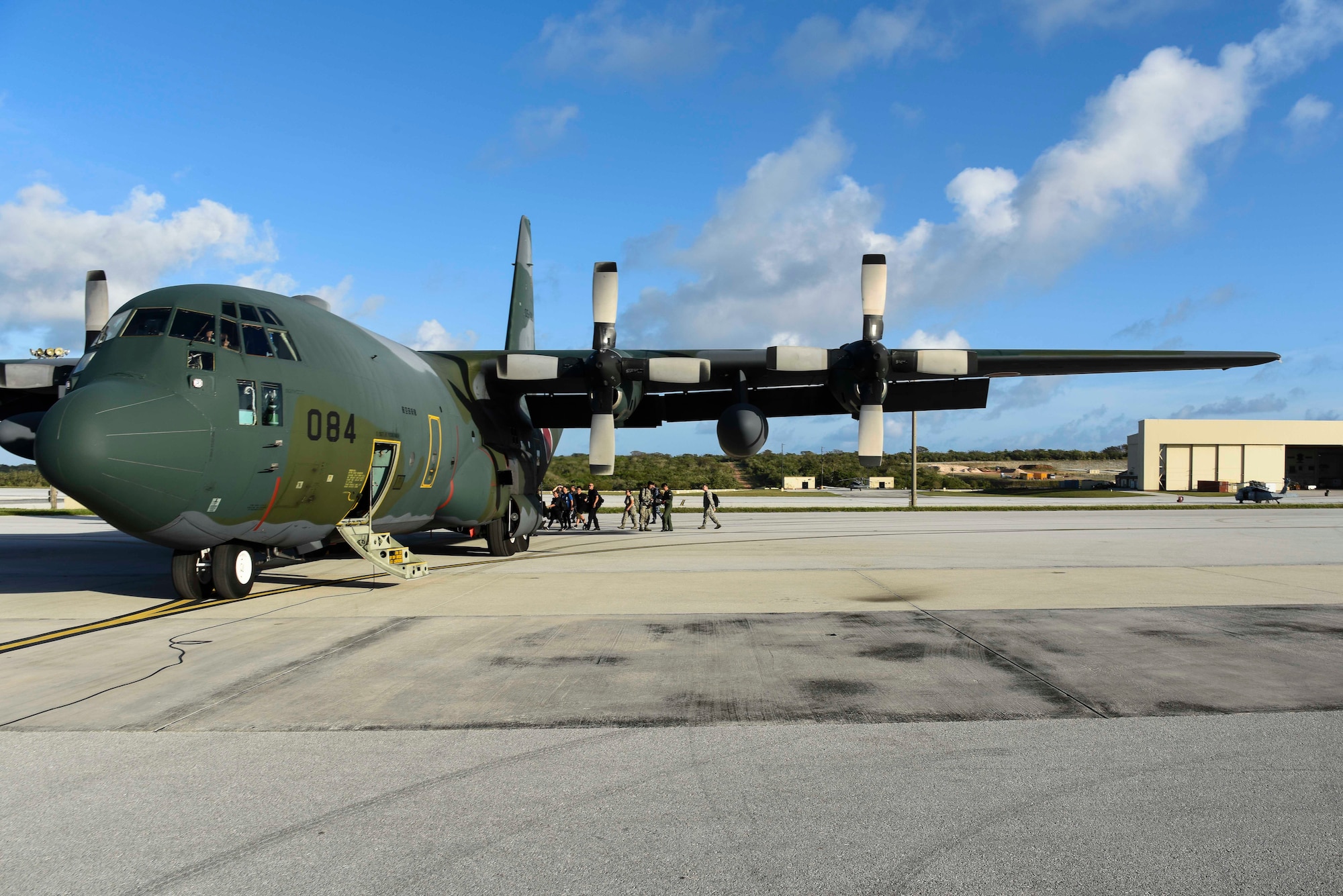 Service members from the United States, Royal Australian Air Force, and Japanese Air Self-Defense Force board a JASDF C-130H for an exercise scenario during Cope North 2019 Feb. 27, 2019, at Andersen Air Force Base, Guam. Service members from the U.S., Royal Australian Air Force, and the Japan Air Self-Defense Force exercised their Humanitarian Assistance and Disaster Relief skills together on Tinian by providing emergency medical care and secure transportation for simulated patients.(U.S. Air Force photo by Tech. Sgt. Jake Barreiro)
