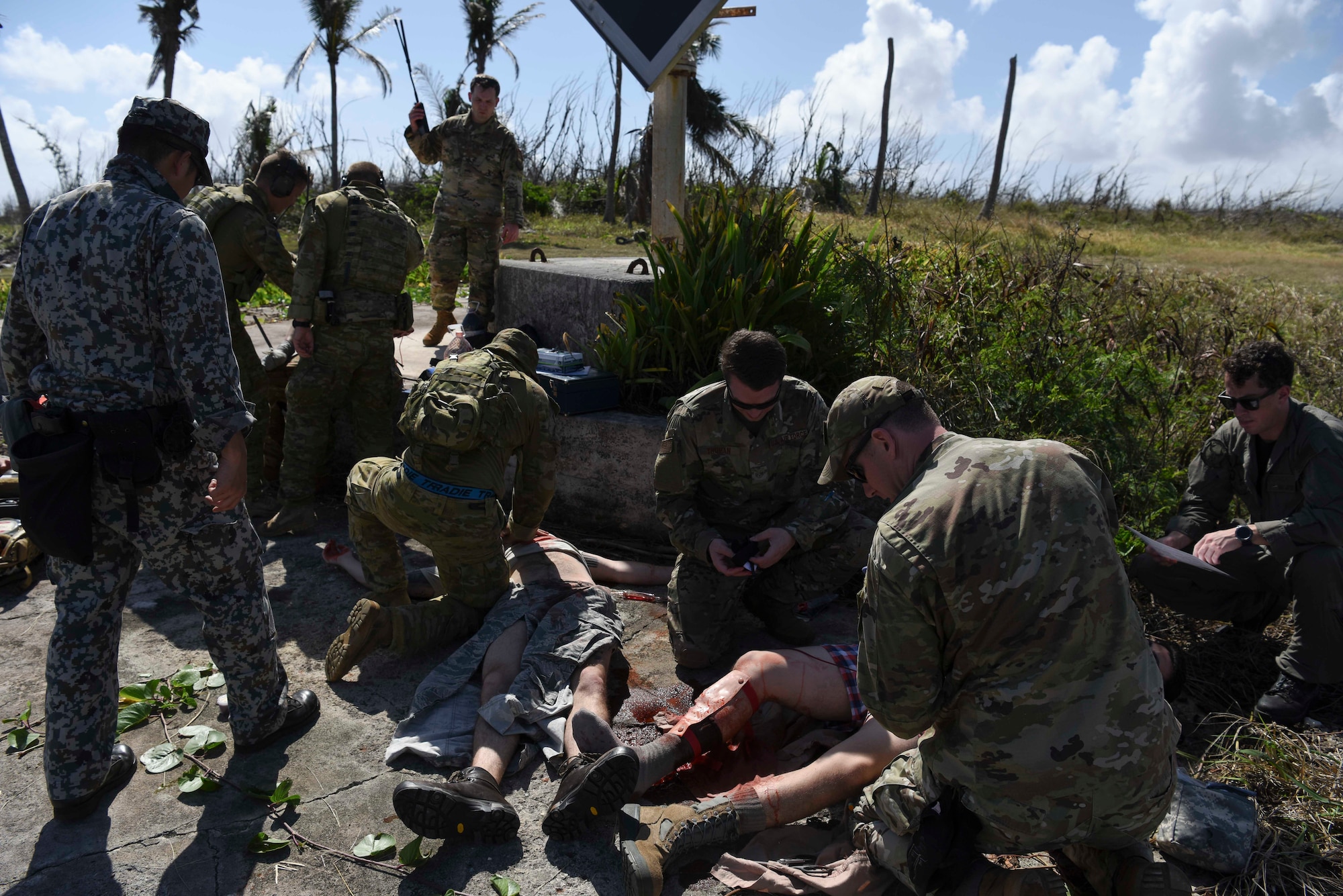 Service members from the United States, Royal Australian Air Force, and Japan Air Self-Defense Force work together to treat simulated injuries on personnel during Cope North 2019, Feb. 27, 2019, at Tinian, Commonwealth of the Northern Marianas.  Service members from the U.S., Royal Australian Air Force, and the Japan Air Self-Defense Force exercised their Humanitarian Assistance and Disaster Relief skills together on Tinian by providing emergency medical care and secure transportation for simulated patients. (U.S. Air Force photo by Tech. Sgt. Jake Barreiro)
