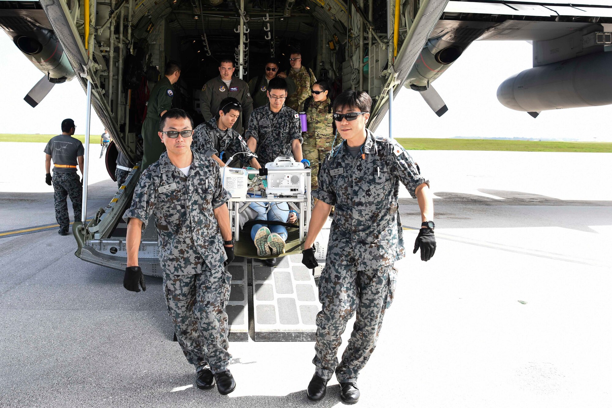 Medical service members from the Japan Air Self-Defense Force perform simulated emergency medical care and transportation on U.S. Airman 1st Class Kelly Destiny, 36 Mobility Response Squadron Air Transportation apprentice, during an exercise scenario for Cope North 2019, Feb. 27, 2019, at Andersen Air Force Base, Guam. Service members from the U.S., Royal Australian Air Force, and the Japan Air Self-Defense Force exercised their Humanitarian Assistance and Disaster Relief skills together on Tinian by providing emergency medical care and secure transportation for simulated patients. (U.S. Air Force photo by Tech. Sgt. Jake Barreiro)