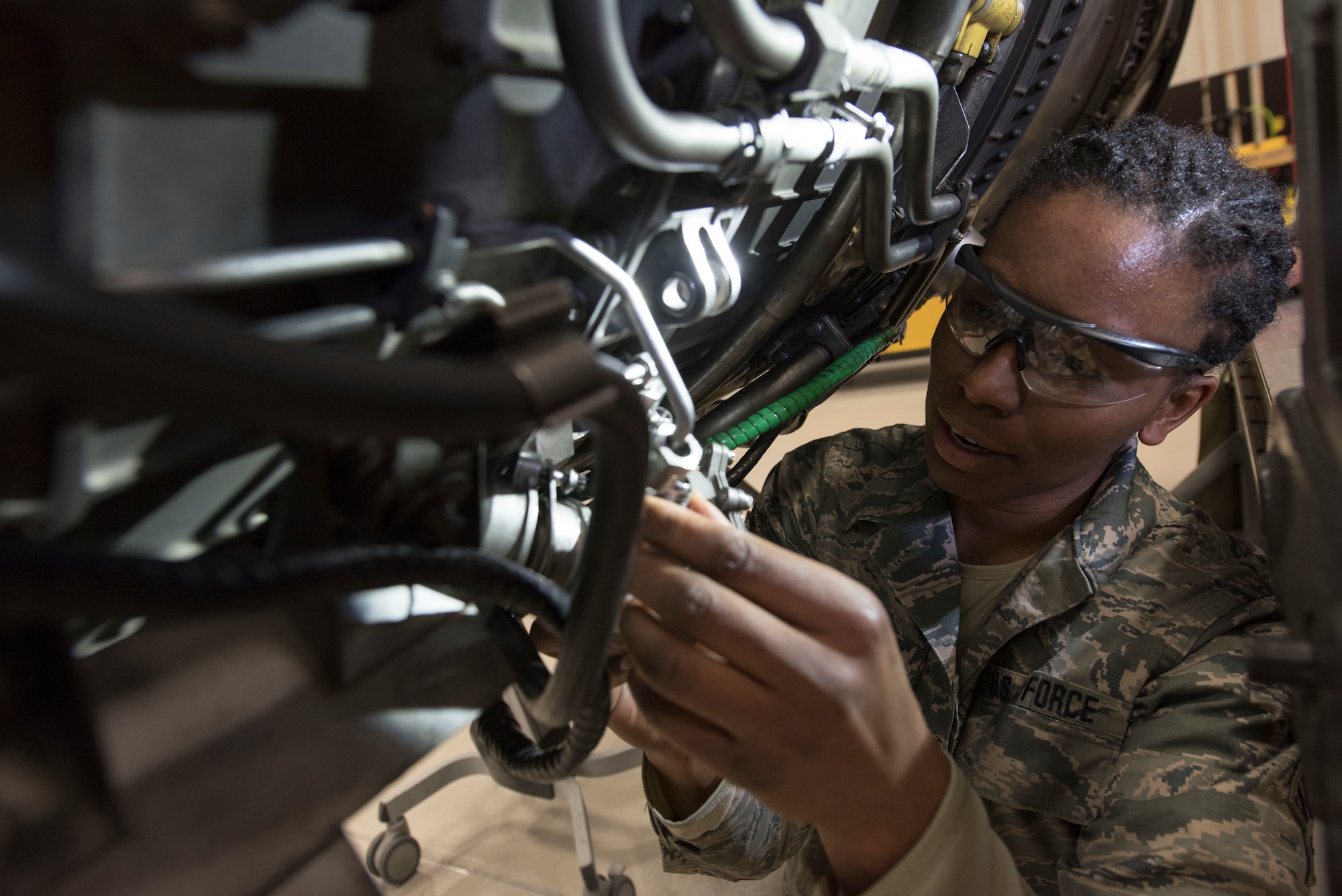 U.S. Air Force Senior Airman Courtney Parker, a 113th Maintenance Squadron aerospace propulsions technician from Joint Base Andrews, Md., repairs an F-16 Fighting Falcon engine at Misawa Air Base, Japan, Feb. 25, 2019. The Misawa central repair facility provides the U.S. Pacific Air Forces with an in-theater option for repairs and overhaul of the GE F110 engines in support of all PACAF F-16 bases. (U.S. Air Force photo by Airman 1st Class Collette Brooks)