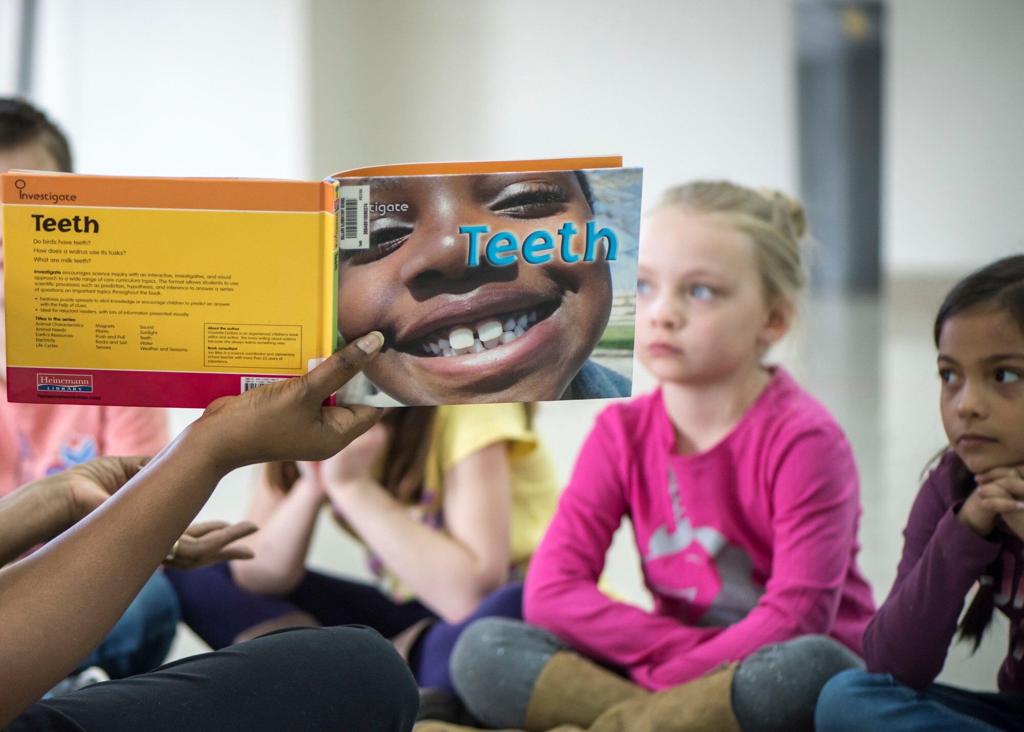 A Sollars Elementary school teacher reads a book on teeth to her students during a National Dental Health Month workshop at Misawa Air Base, Japan, Feb. 26, 2019. Every year in February, U.S. Air Force dental squadrons educate the youth regarding proper oral hygiene in an effort to give back to the community. (U.S. Air Force photo by Airman 1st Class Collette Brooks)
