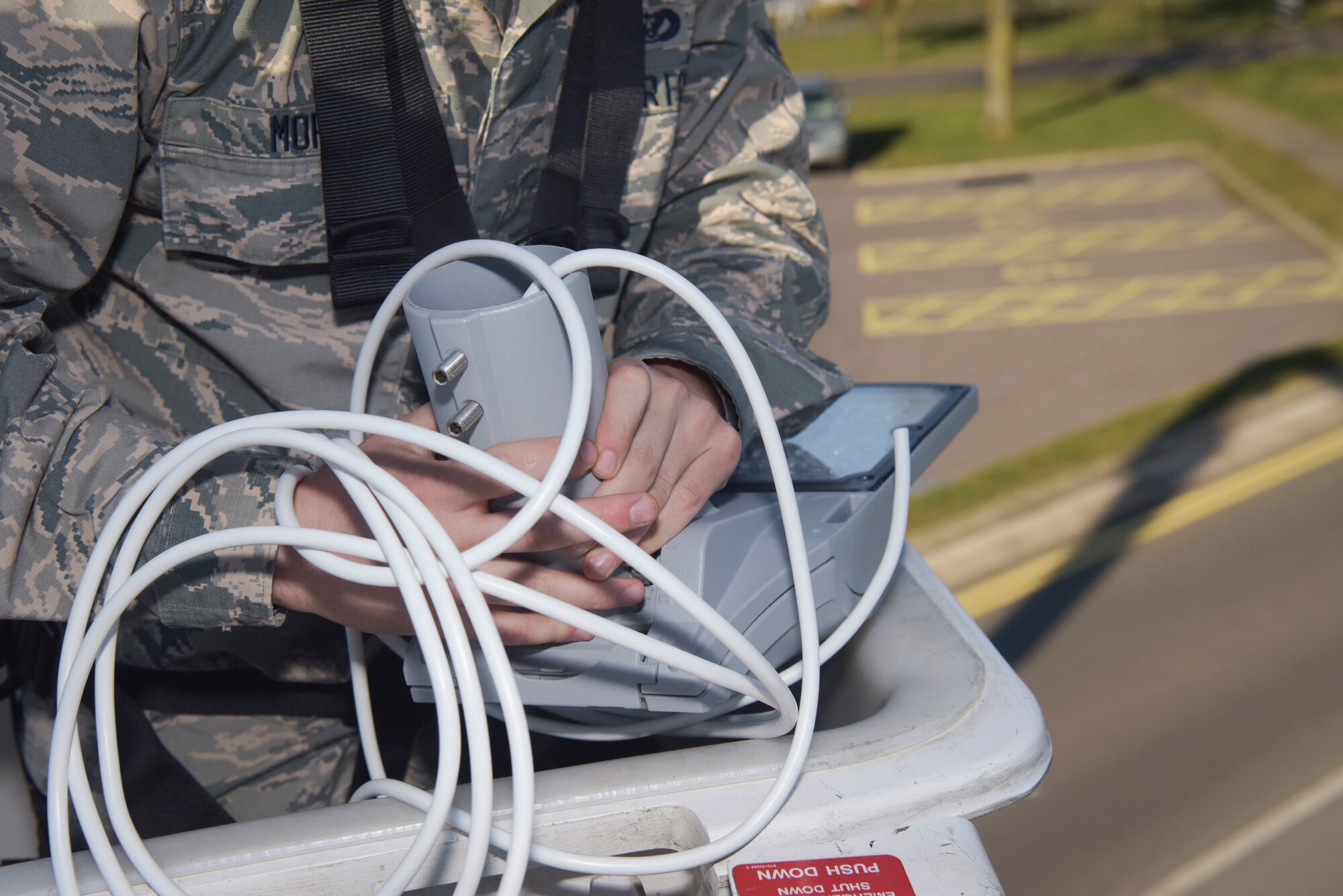 U.S. Air Force Airman Benjamin Moran, 100th Civil Engineer Squadron electrical systems apprentice, wires a replacement head for a new light-emitting diode (LED) street light at RAF Mildenhall, England, Feb. 25, 2019. The bulb replacement will save RAF Mildenhall money in replacement bulbs, electricity and man-hours. (U.S. Air Force photo by Airman 1st Class Alexandria Lee)