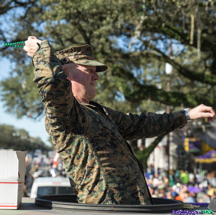 Maj. Gen. Bradley S. James, commander of Marine Forces Reserve and Marine Forces North, tosses beads to a member of the crowd while atop a 7-ton truck during the Krewe of Alla Mardi Gras parade in New Orleans, Feb. 24, 2019. James along with key leaders from MARFORRES took part in the parade to celebrate the Mardi Gras season with the New Orleans community. (U.S. Marine Corps photo by Sgt. Markeith D. Hall/Released).
