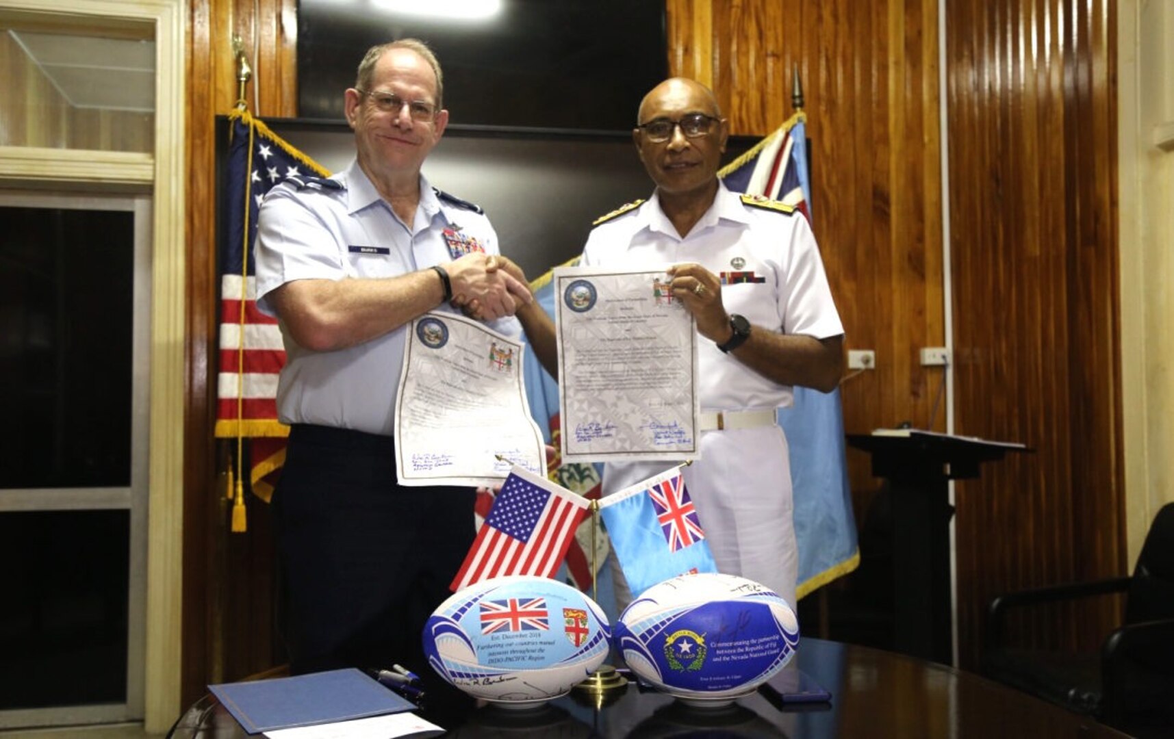 Brigadier General William R. Burks, Adjutant General for the State of Nevada (left) with Rear Admiral Viliame Naupoto, Commander of the Republic of Fiji Military Forces enter the island country into the State's Partnership Program.