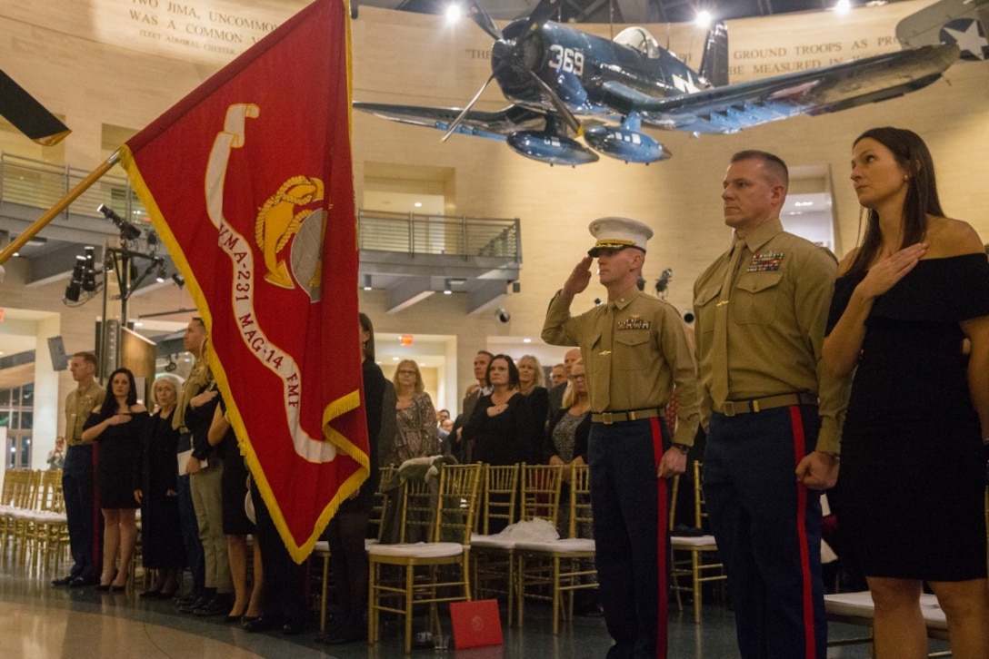 U.S. Marine Lt. Col. Eric Grunke, right, salutes the colors during the Marine Attack Squadron (VMA) 231 100 year anniversary celebration at Quantico, Virginia, Feb. 23, 2019.