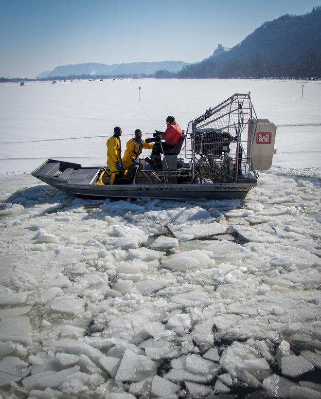 men in airboat conduct rescue training on icy lake