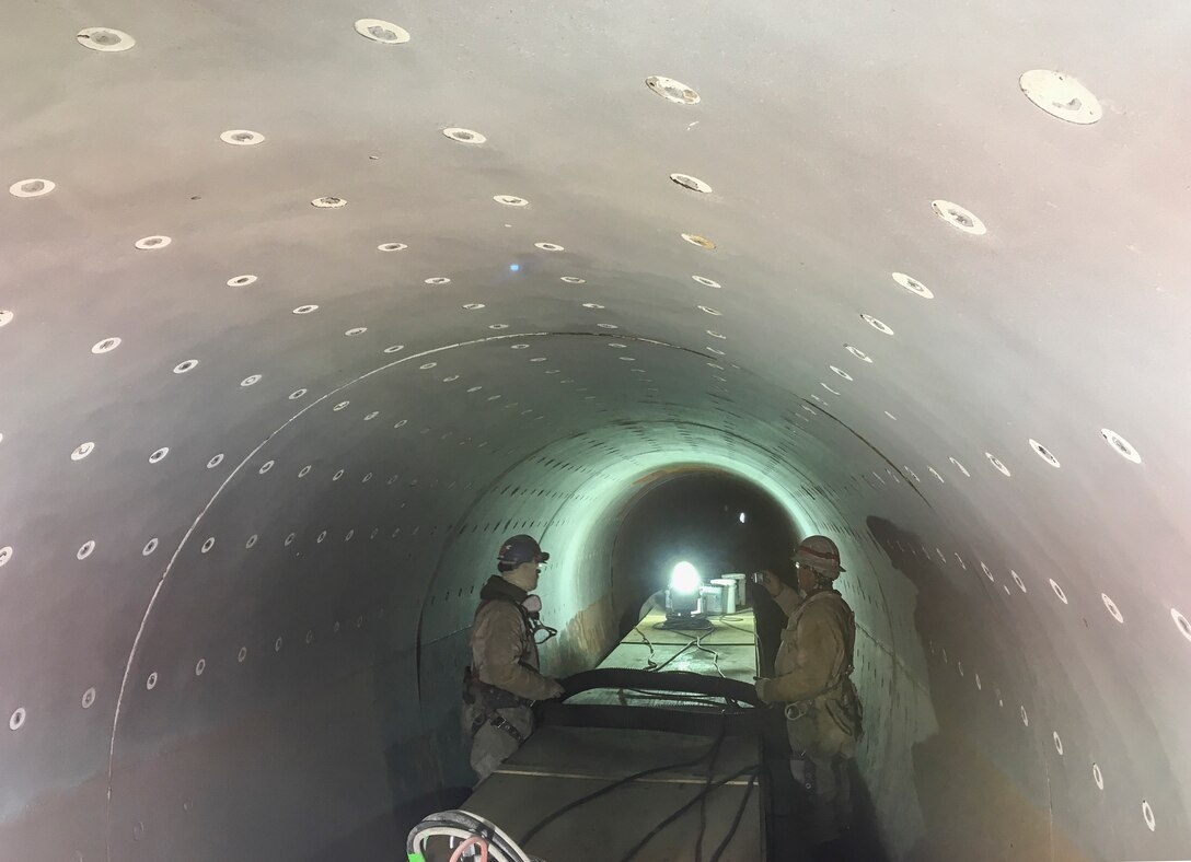 men in tunnel working