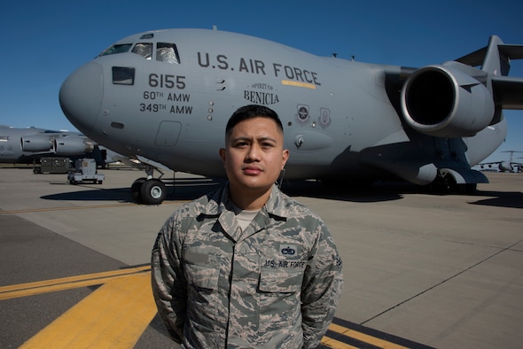 Tech. Sgt. Ron, 860th Aircraft Maintenance Squadron expediter, poses for a photo near a C-17 Globemaster III Feb. 19, 2019 at Travis Air Force Base, California. Ron was one of two Travis Airmen selected to become enlisted remotely piloted aircraft pilots during the 2019 selection cycle. The Air Force conducted the first enlisted RPA training course in October 2016. Photo altered for security purposes. (U.S. Air Force photo by Tech. Sgt. James Hodgman)