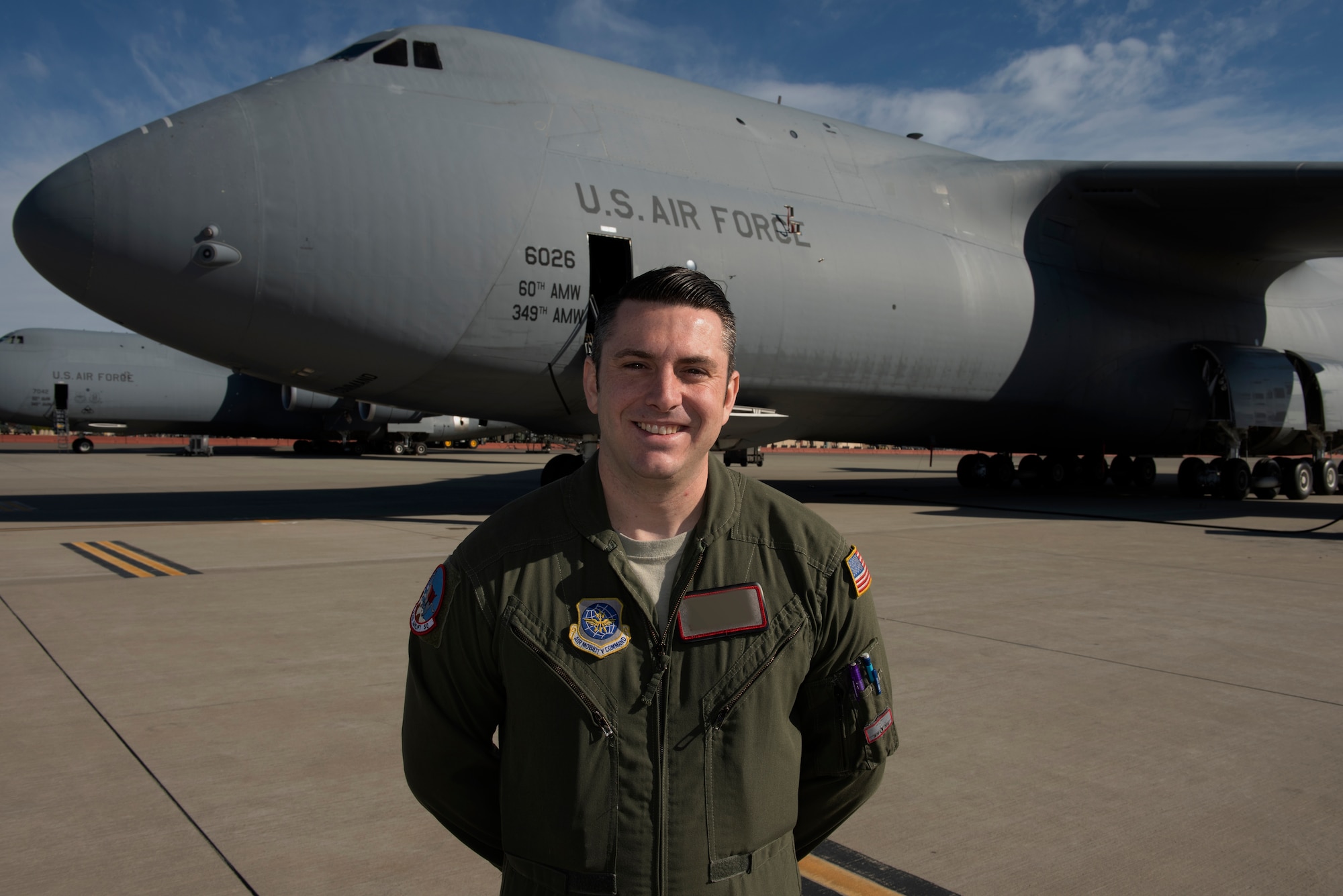 Staff Sgt. Stacy, 22d Airlift Squadron NCO in charge of supply, poses for a photo near a C-5M Super Galaxy Feb. 20, 2019 at Travis Air Force Base, California. Stacy was one of two Travis Airmen selected to become enlisted remotely piloted aircraft pilots during the 2019 selection cycle. The Air Force conducted the first enlisted RPA training course in October 2016. Photo altered for security purposes. (U.S. Air Force photo by Tech. Sgt. James Hodgman)