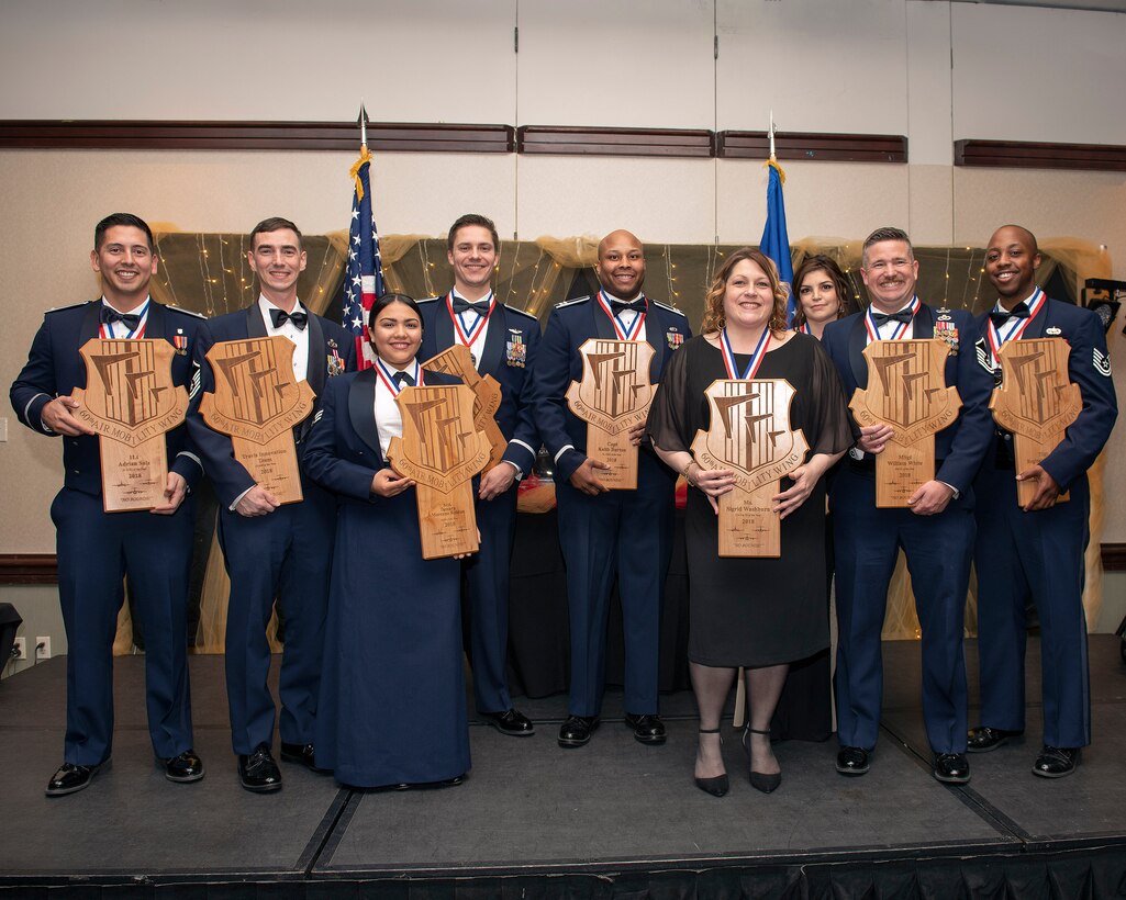 U.S. Air Force Col. Jeffrey Nelson, 60th Air Mobility Wing commander and Chief Master Sgt. Derek Crowder, 60th Air Mobility Wing command chief present annual awards to members of Team Travis during a banquet at Travis Air Force Base, California Feb. 22, 2019. (U.S. Air Force photo by Louis Briscese)