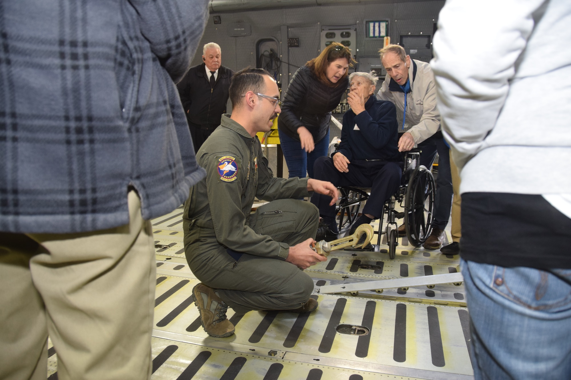 Pete Peterson, an 89-year-old Navy vet (seated), listens as Airman 1st Class Ryan Biggs, 68th Airlift Squadron loadmaster, describes the many features of the cargo deck on the C-5M Super Galaxy Feb. 25, 2019 at Joint Base San Antonio-Lackland, Texas.