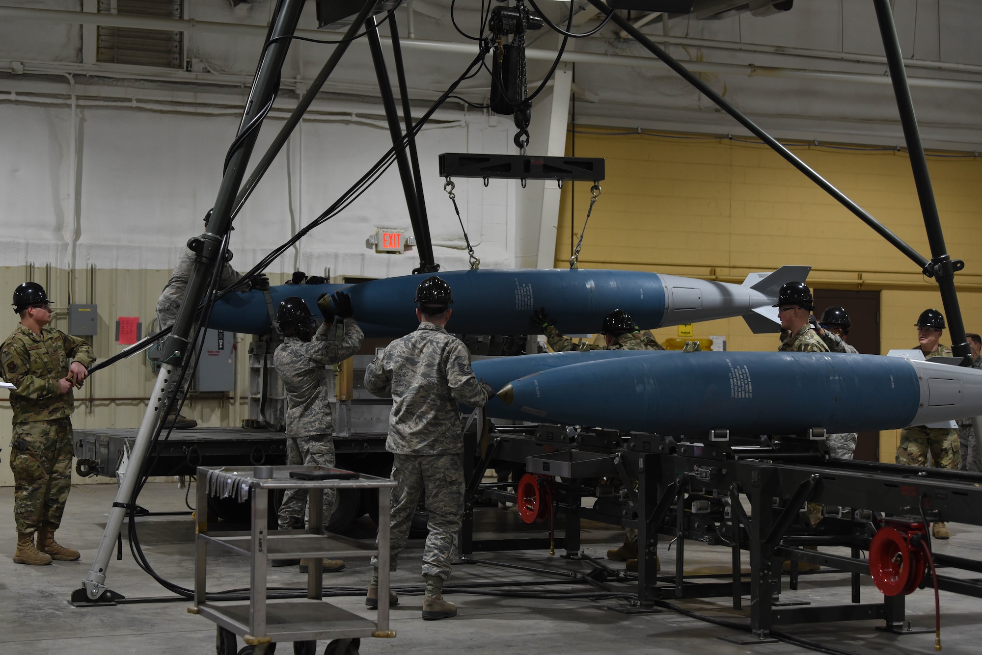 Airmen from the 28th Munitions Squadron lower a completed bomb at Ellsworth Air Force Base S.D., Feb. 5, 2019, during a qualifying round for the second annual Air Force Combat Operations Competition at the major command level. The competition is Air Force-wide and is used to determine the best of the best in munitions operations. (U.S. Air Force photo by Airman John Ennis)