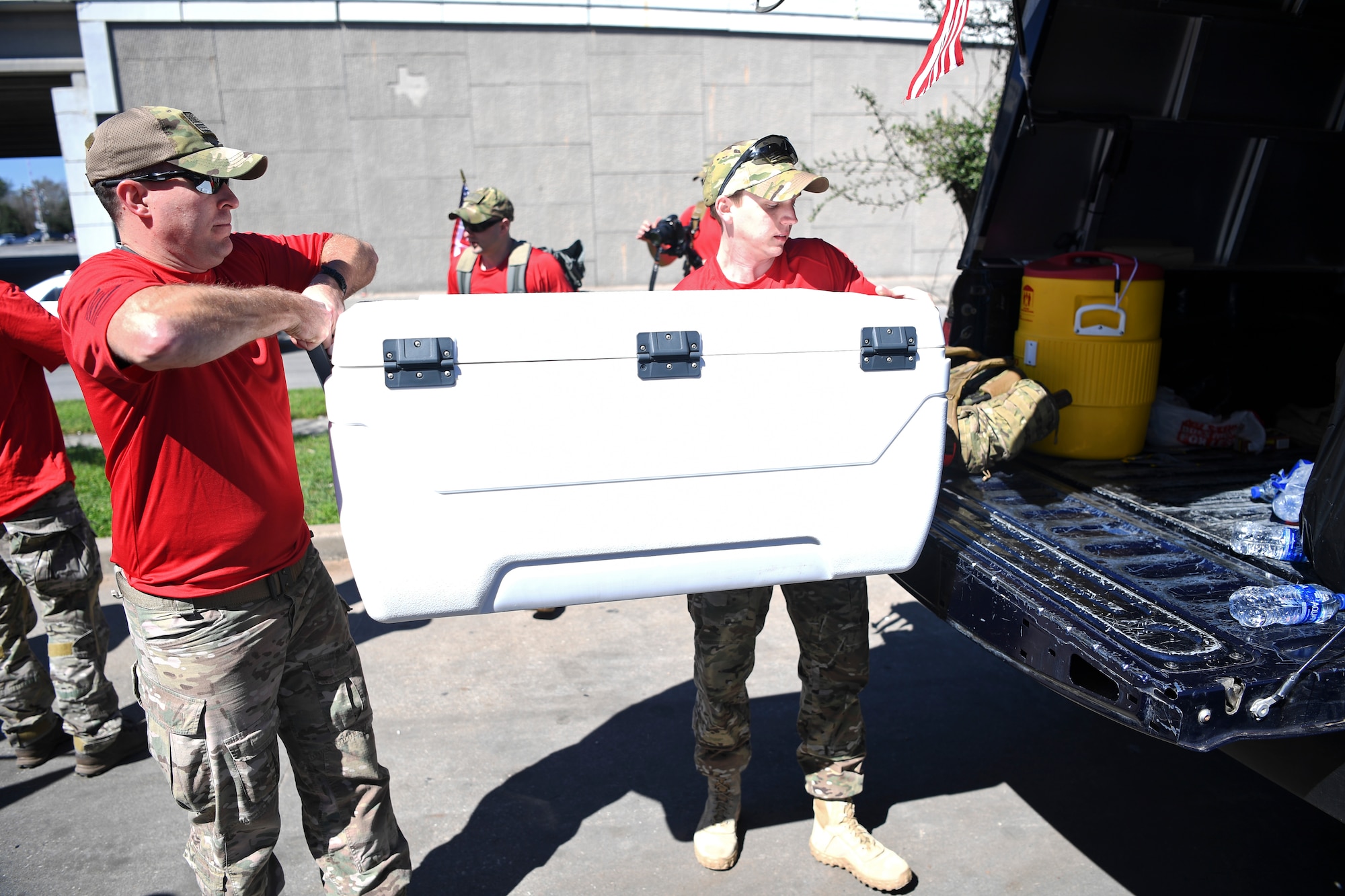 Air Commandos assigned to the 24th Special Operations Wing load coolers of water and supplies onto trucks for the Special Tactics Memorial March Feb. 24, 2014, near Houston, Texas.