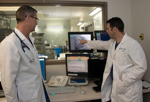 U.S. Air Force Lt. Col. (Dr.) Joseph Sky, (left) chief of cardiology and U.S. Air Force Lt. Col. (Dr.) Shea Pribyl, surgeon, both with the 60th Medical Group, David Grand USAF Medical Center, discuss the best approach to treat a blocked artery, Feb. 26, 2019, at Travis Air Force Base California. With increased emphasis placed on non-invasive cardiology procedures and imaging techniques done on an outpatient basis, DGMC uses some of the latest technology in the evaluation and treatment of heart diseases.(U.S. Air Force photo by Heide Couch)