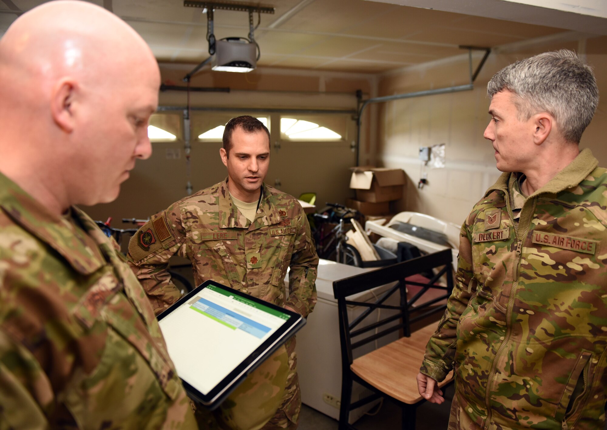 U.S. Air Force Tech. Sgt. Thomas Decker, 60th Aerial Port Squadron NCO in charge of bunker operations, speaks with U.S. Air Force Maj. Philip Lere, 60th APS operations officer, and U.S. Air Force Chief Master Sgt. Scott Sikorski, 60th APS superintendent, regarding his home, Feb. 25 at Travis Air Force Base, Calif. Decker was one of many Airmen whose home was reviewed by squadron leadership amid an Air Force-wide effort addressing potential or chronic issues for base housing residents. (U.S. Air Force photo by Airman 1st Class Christian Conrad)
