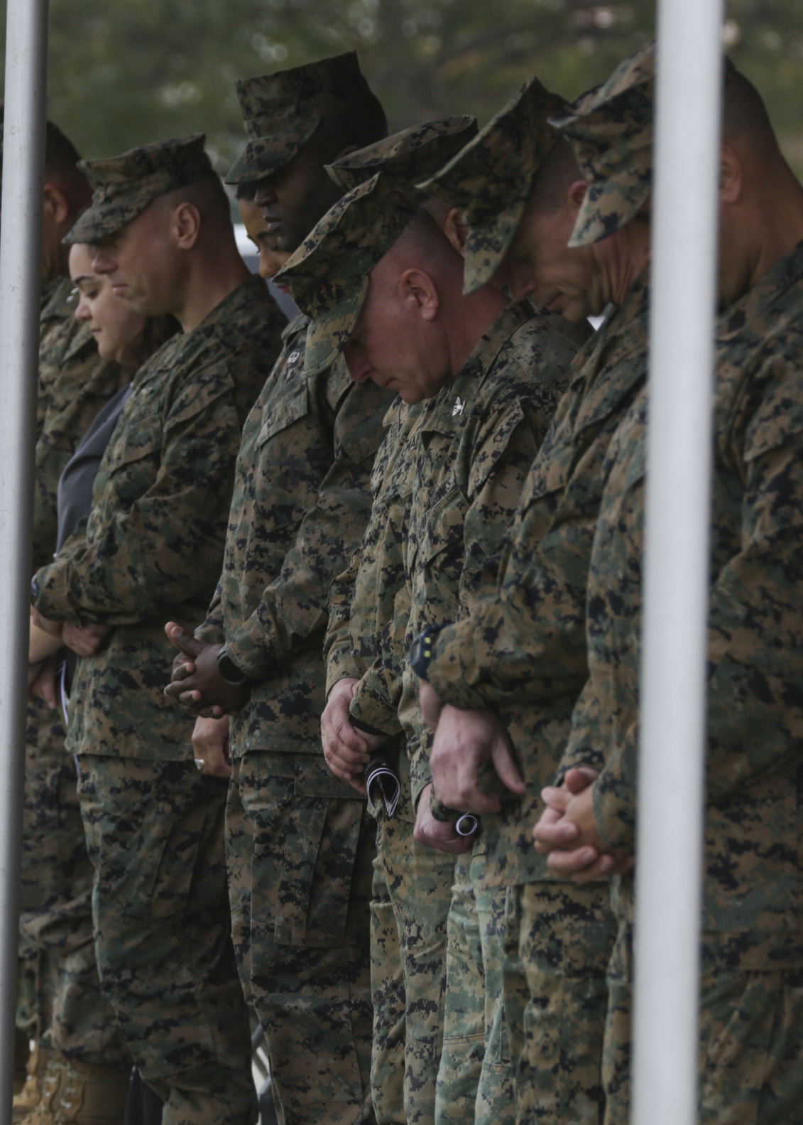 Senior leaders of Marine Wing Headquarters Squadron (MWHS) 3, bow their heads for prayer during Sgt. Maj. Delwin K. Ellington's relief ceremony at Marine Corps Air Station Miramar, Calif., Feb. 26. Ellington completed a three-year tour with his 3rd MAW family and is slated to assume the post as sergeant major of Special Purpose Marine Air Ground Task Force-Crisis Response-Central Command (SPMAGTF-CR-CC) 19.2 and deploy to Ahmad al-Jaber Air Base, Kuwait, late spring. (U.S. Marine Corps photo by Cpl. Joshua S. McAlpine)