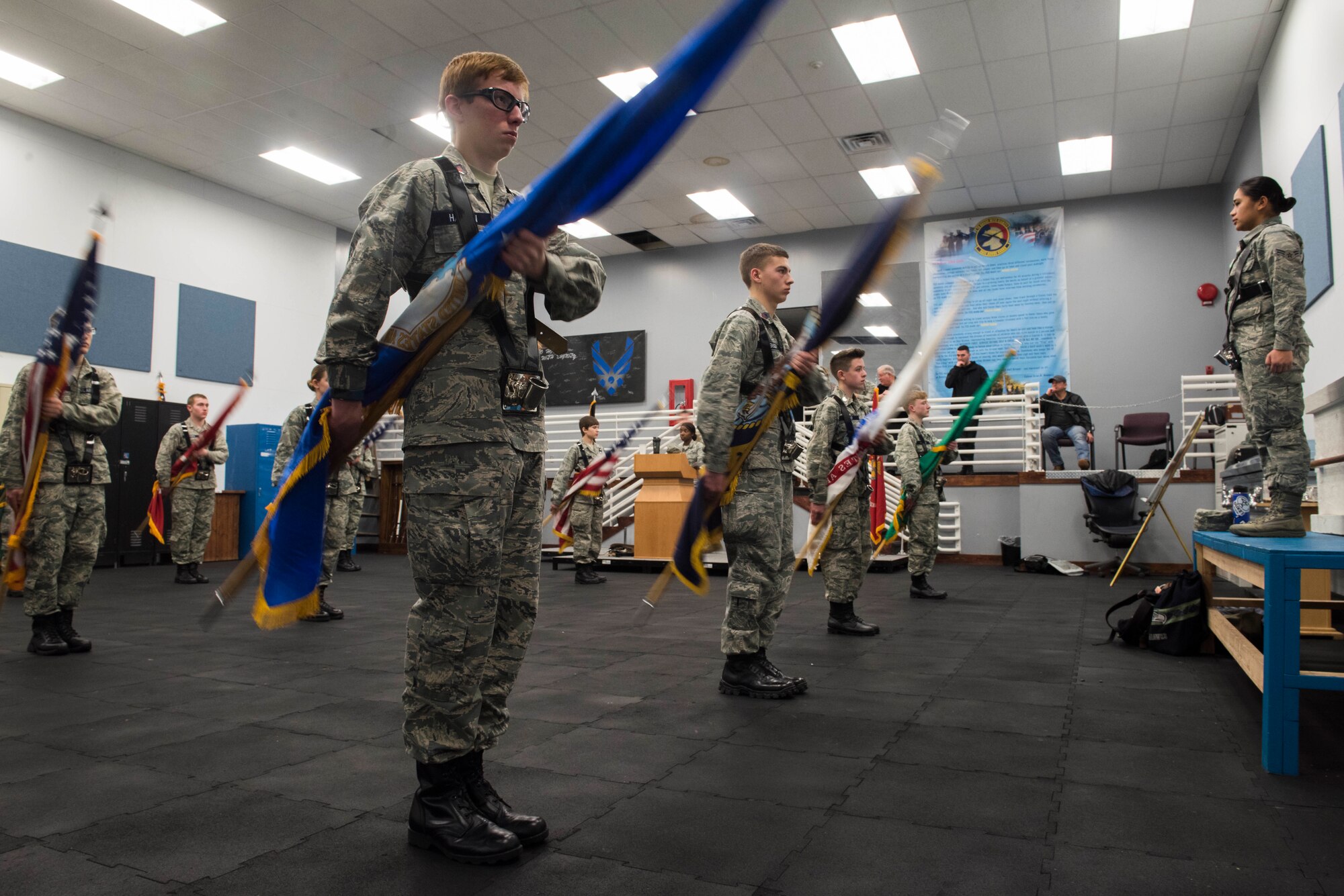 U.S. Air Force Airman 1st Class Larrah Lara, 92nd Air Refueling Wing base honor guardsman, instructs Civil Air Patrol cadets from the 21st Fairchild Composite Squadron on the movement of “present colors’ at Fairchild Air Force Base, Washington, Feb. 26, 2019.  When “presenting the colors” honor guardsmen keep the U.S. flag upright in the “port arms” position while slowly lowering the rest of the flags. (U.S. Air Force photo by Airman 1st Class Lawrence Sena)