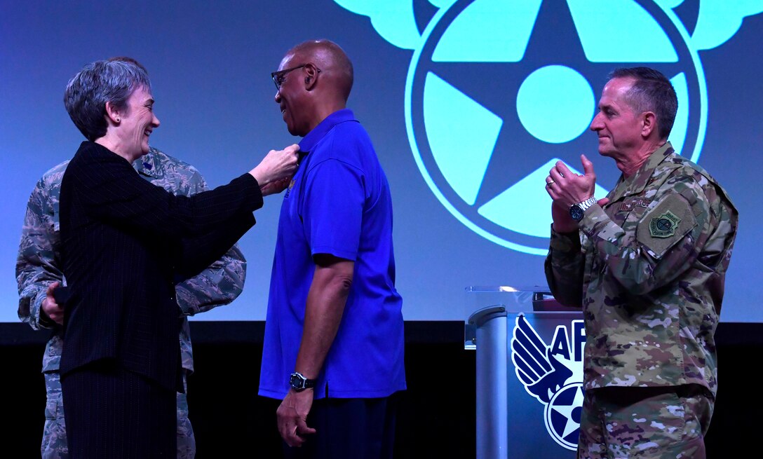 Secretary of the Air Force Heather Wilson and Air Force Chief of Staff Gen. David L. Goldfein present an award to the retired Gen. Larry O. Spencer, Air Force Association president, during the Air Force Association’s Air, Space and Cyber Conference in Orlando, Fla., Feb. 28, 2019. (U.S. Air Force photo by Wayne Clark)