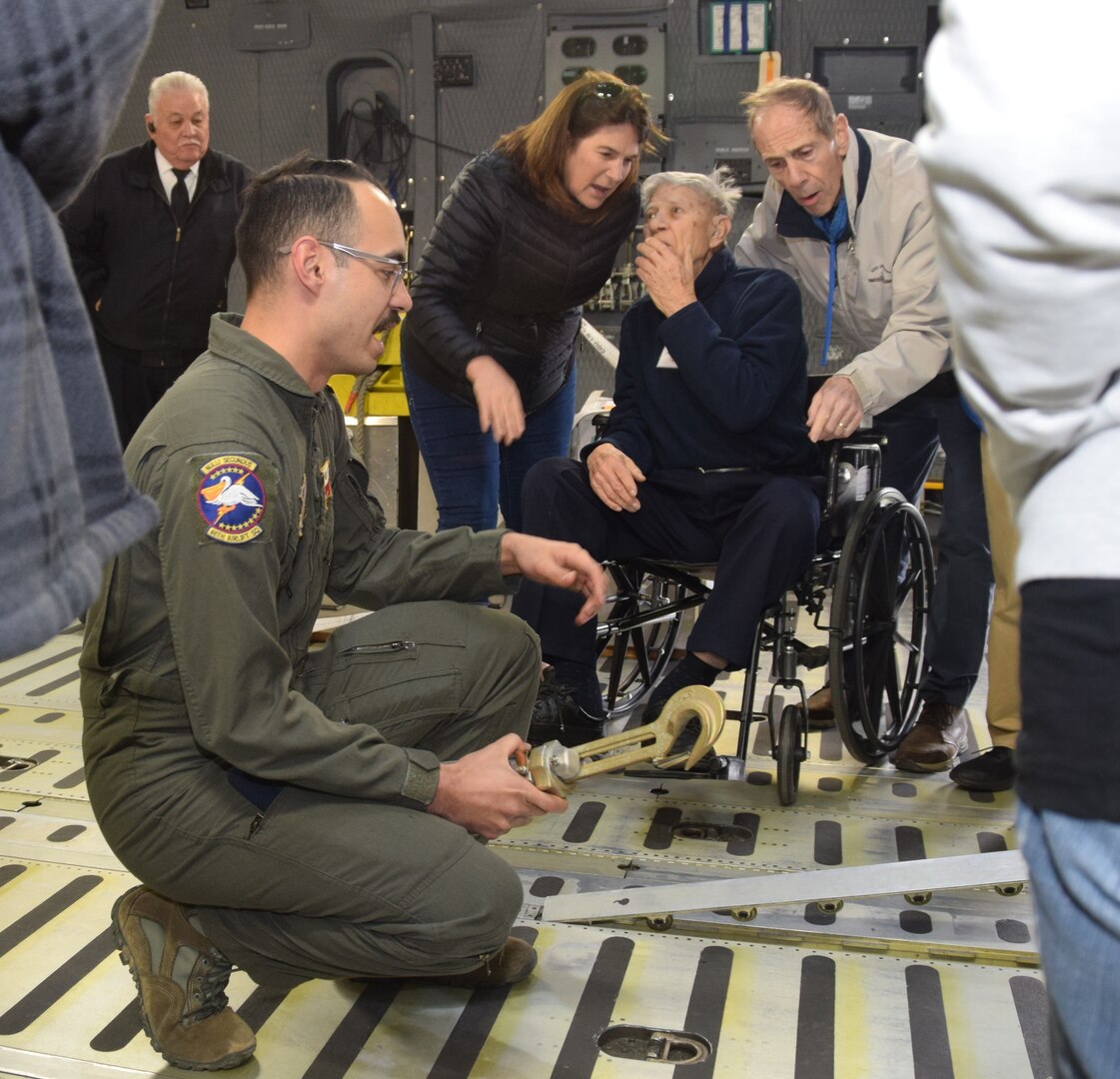 Pete Peterson, an 89-year-old Navy vet (seated), listens as Airman 1st Class Ryan Biggs, 68th Airlift Squadron loadmaster, describes the many features of the cargo deck on the C-5M Super Galaxy Feb. 25, 2019 at Joint Base San Antonio-Lackland, Texas. Peterson, a Navy veteran, was part of a group attending a reunion of the USS Lloyd Thomas in San Antonio.