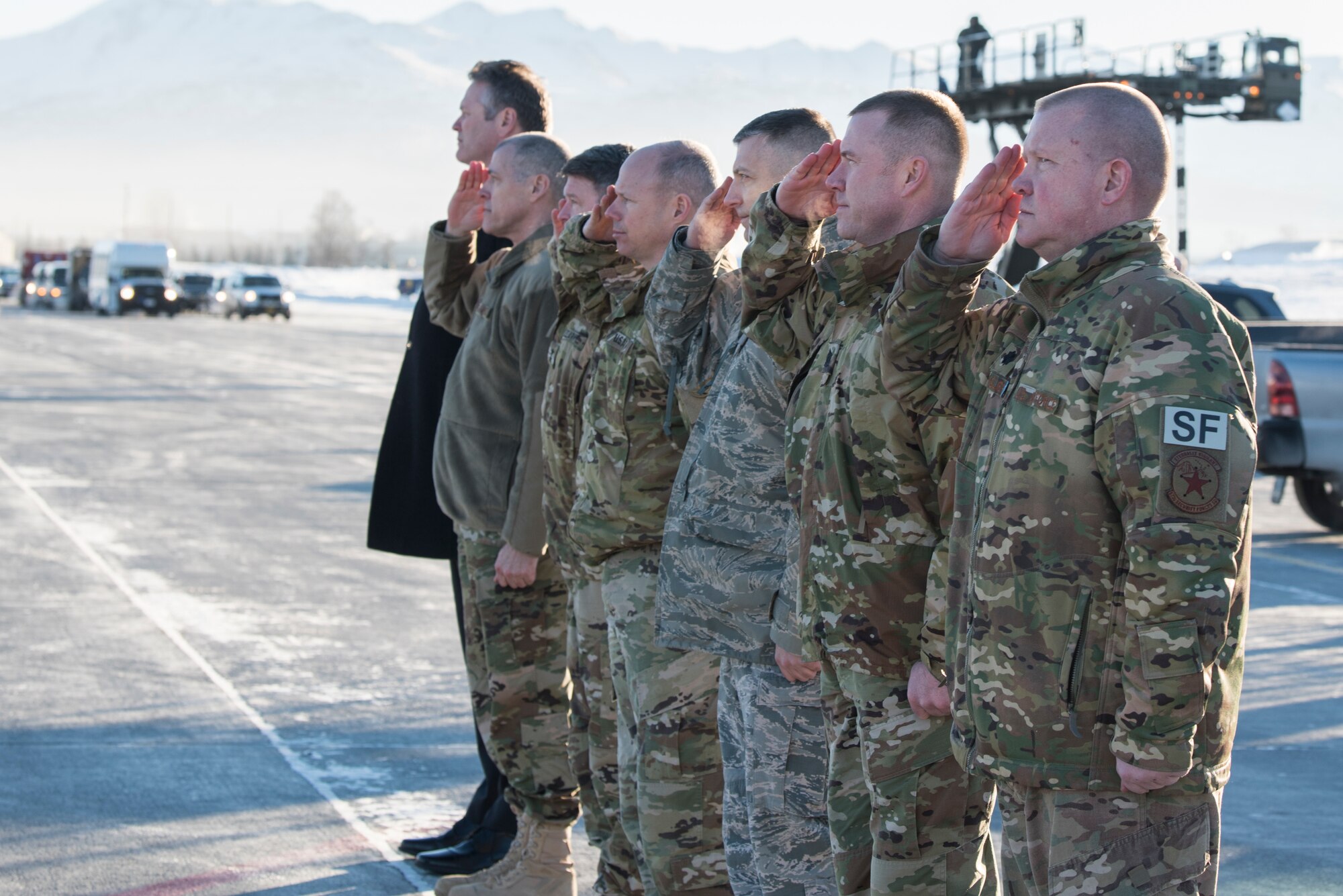 Joint Base Elmendorf-Richardson senior leadership salutes while Alaska Gov. Michael Dunleavy, far left, greets President Donald Trump following his arrival to JBER, Alaska, Feb. 28, 2019. The president talked to more than 100 personnel while his plane refueled before continuing his travel to Joint Base Andrews, Maryland.