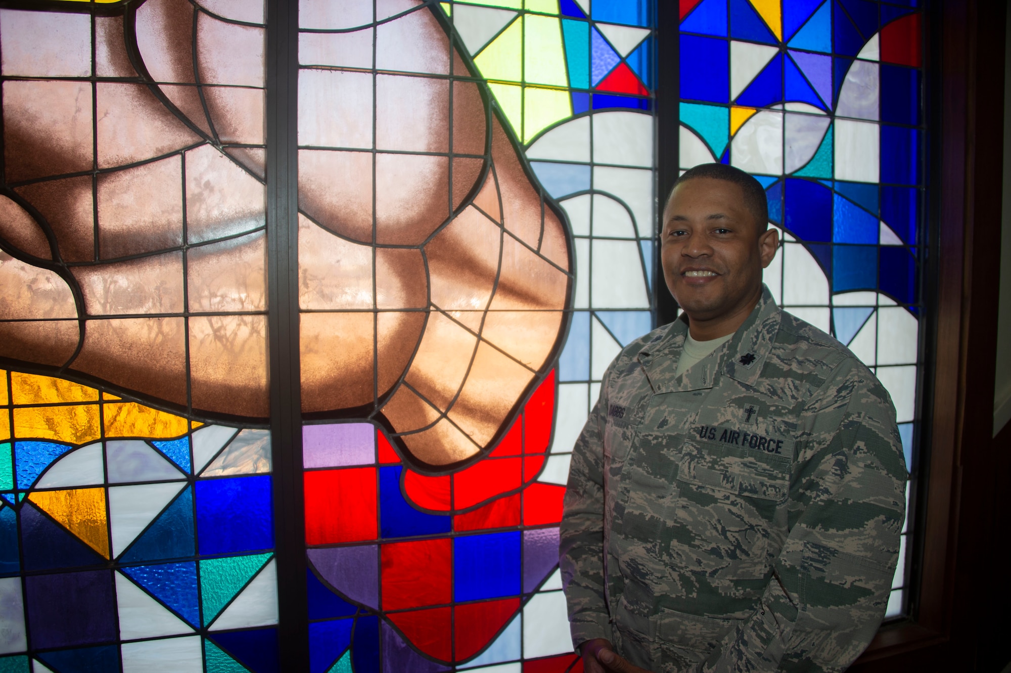 U.S. Air Force Chaplain Lt. Col. Steve Dabbs, the wing Chaplin of the 97th Air Mobility Wing, stands by the Chapels stained glass, Feb. 25, 2019, at Altus Air Force Base, Okla