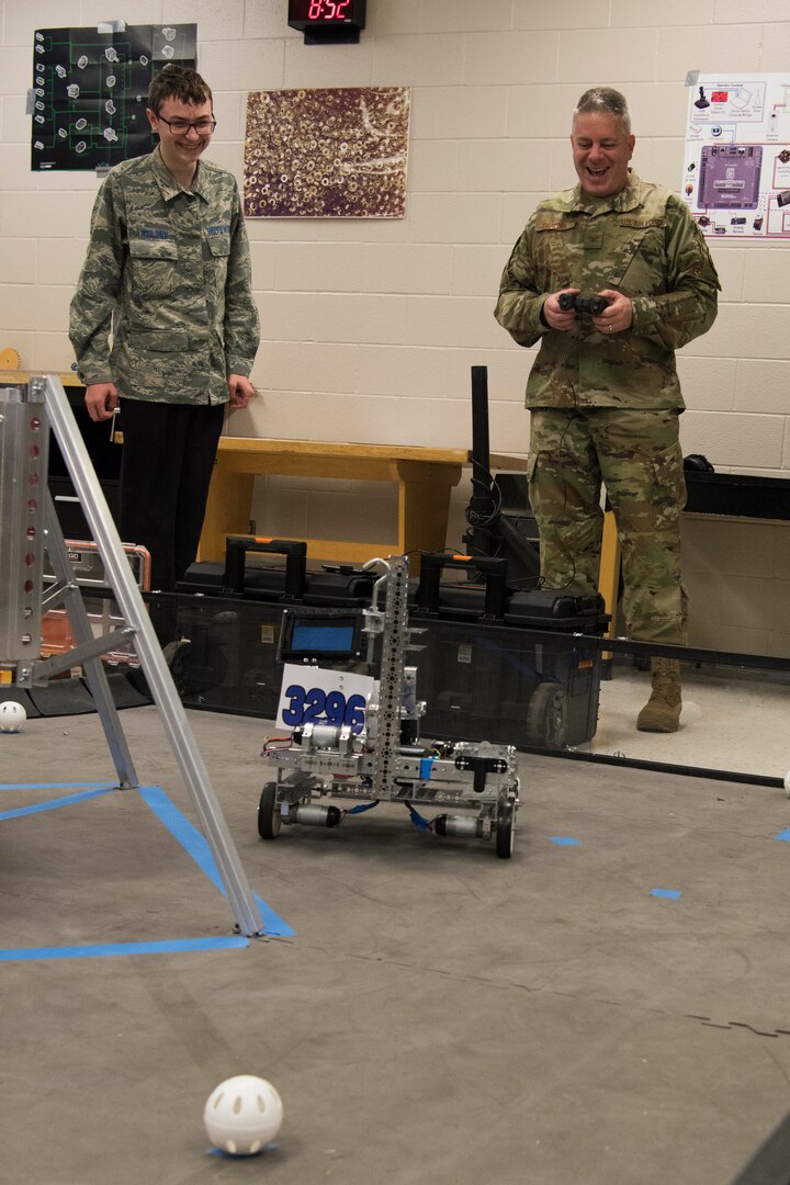 A Bots in Blue club members showcases their robot to Col. Robert W. Trayers Jr., Air Force Recruiting Service vice commander, during a visit to Virginia Allred Stacey Junior/Senior High School Feb. 13, 2019, at Joint Base San Antonio-Lackland, Texas.
