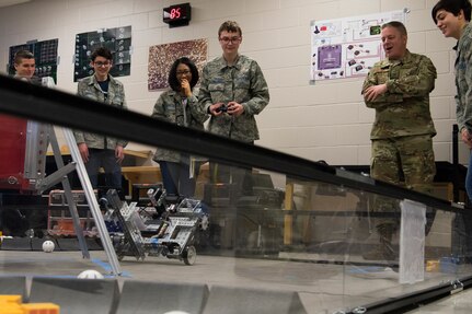 A Bots in Blue club members showcases their robot to Col. Robert W. Trayers Jr., Air Force Recruiting Service vice commander, during a visit to Virginia Allred Stacey Junior/Senior High School Feb. 13, 2019, at Joint Base San Antonio-Lackland, Texas.