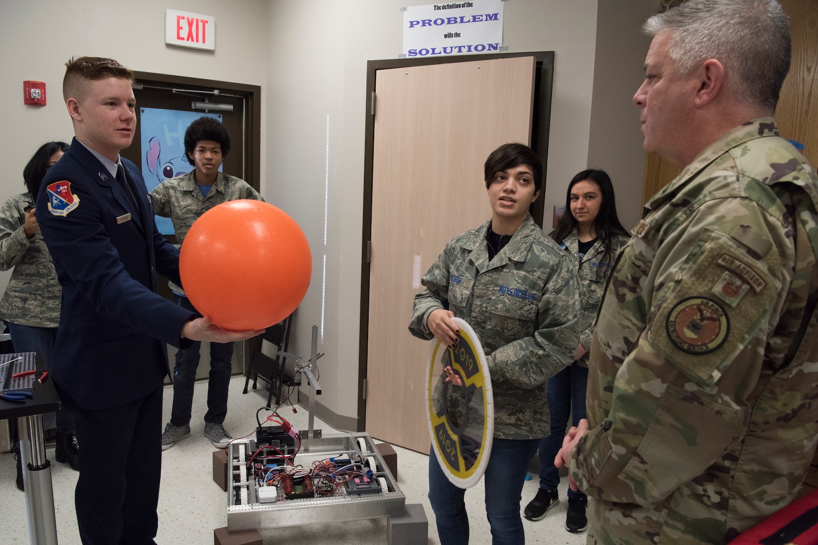 Jordan Peterson and Madison Sligh, Bots in Blue members, showcase tools their club’s robots must be able to use during competitions to Col. Robert W. Trayers Jr., Air Force Recruiting Service vice commander, during a visit to Virginia Allred Stacey Junior/Senior High School Feb. 13, 2019, at Joint Base San Antonio-Lackland, Texas.
