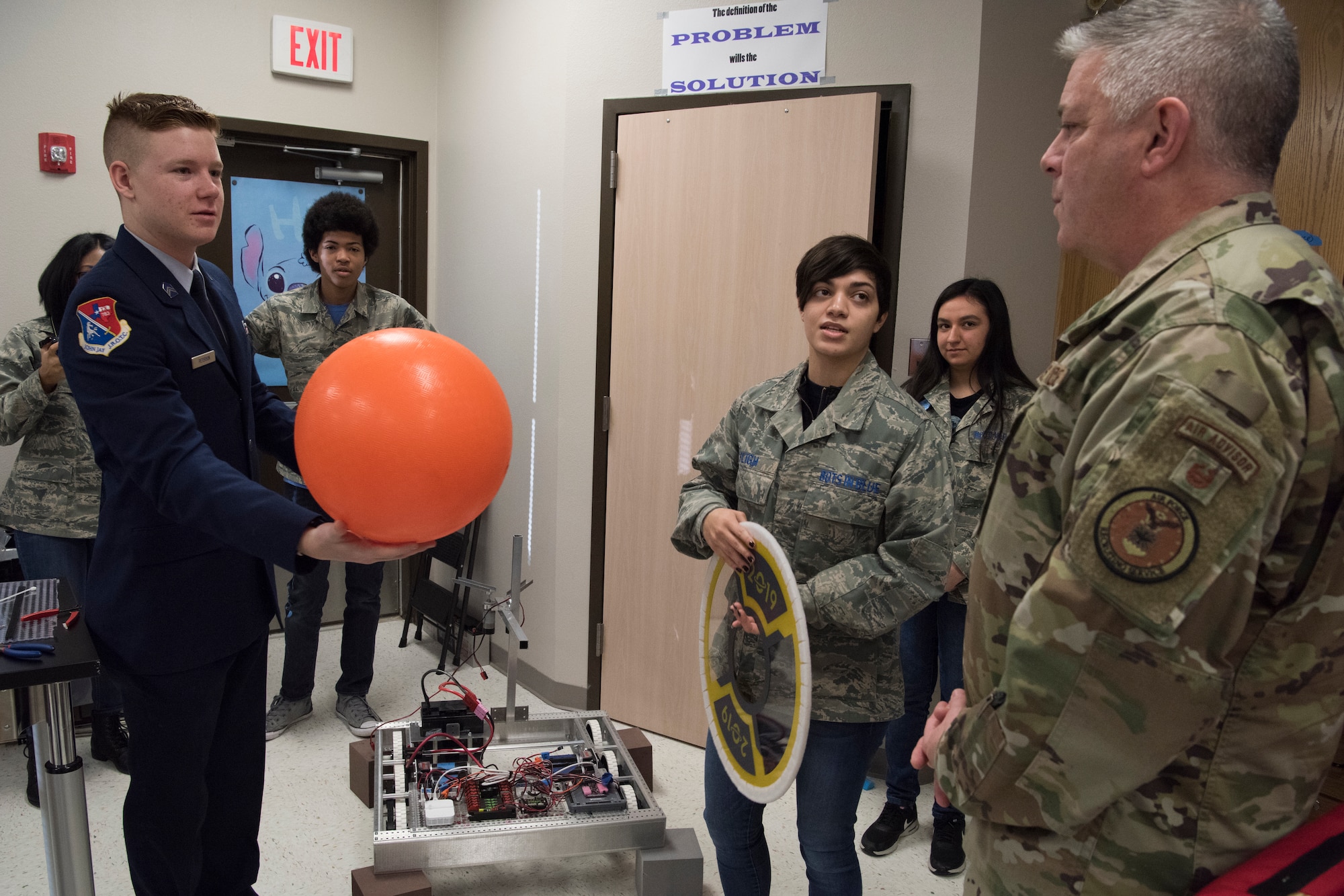 Jordan Peterson and Madison Sligh, Bots in Blue members, showcase tools their club’s robots must be able to use during competitions to Col. Robert W. Trayers Jr., Air Force Recruiting Service vice commander, during a visit to Virginia Allred Stacey Junior/Senior High School Feb. 13, 2019, at Joint Base San Antonio-Lackland, Texas.