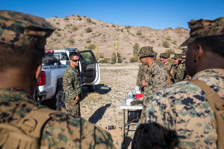 U.S. Marines and Sailors assigned to Marine Corps Air Station (MCAS) Yuma's Search and Rescue (SAR) unit talk about the SAR unit's mission to non-commisioned officers (NCOs) from MCAS Yuma, Ariz., Feb. 7, 2019 as a part of "Operation Backbone." Operation Backbone is a quarterly unit exercise meant to strengthen the warrior's spirit in the non-commisioned officers (NCOs) and promote cohesion between them. The exercise consisted of a hike with the Headquarters and Headquarters Squadron (H&HS)  commanding officer and acting sergeant major, several classes, and a warriors night. Classes included simulated room clearing training, terrain model training, improvised explosive devices (IED) training, and the Family Advocacy Program on station sent out a representative to talk to the NCOs about leadership. (U.S. Marine Corps photo by Cpl. Isaac D. Martinez)