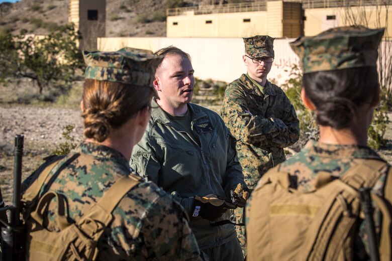 U.S. Marines and Sailors assigned to Marine Corps Air Station (MCAS) Yuma's Search and Rescue (SAR) unit talk about the SAR unit's mission to non-commisioned officers (NCOs) from MCAS Yuma, Ariz., Feb. 7, 2019 as a part of "Operation Backbone." Operation Backbone is a quarterly unit exercise meant to strengthen the warrior's spirit in the non-commisioned officers (NCOs) and promote cohesion between them. The exercise consisted of a hike with the Headquarters and Headquarters Squadron (H&HS)  commanding officer and acting sergeant major, several classes, and a warriors night. Classes included simulated room clearing training, terrain model training, improvised explosive devices (IED) training, and the Family Advocacy Program on station sent out a representative to talk to the NCOs about leadership. (U.S. Marine Corps photo by Cpl. Isaac D. Martinez)