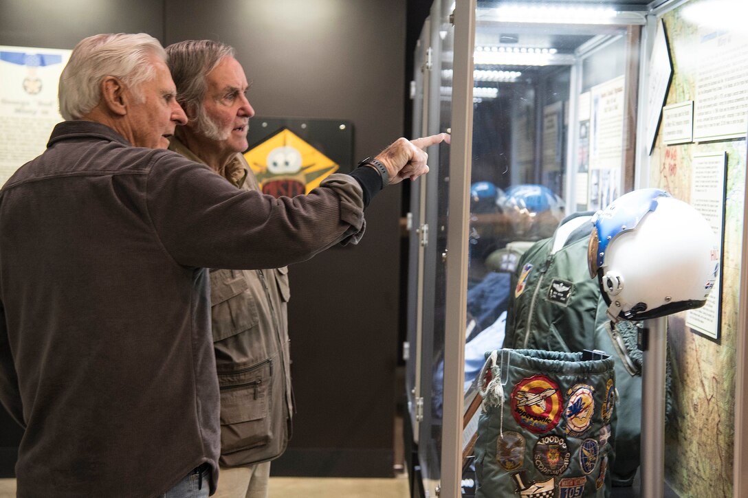 DAYTON, Ohio -- National Aviation Hall of Fame enshrinees Lt. Col.(Ret.)Dick Rutan and Burt Rutan view items that Dick Rutan donated to the National Museum of the USAF after his service as an F-100 pilot in the Southeast Asia War. (U.S. Air Force photo by Ken LaRock)