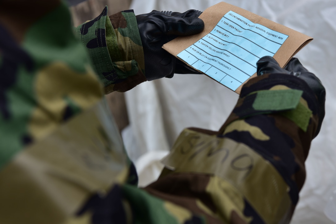 Airmen looks at decontamination package
